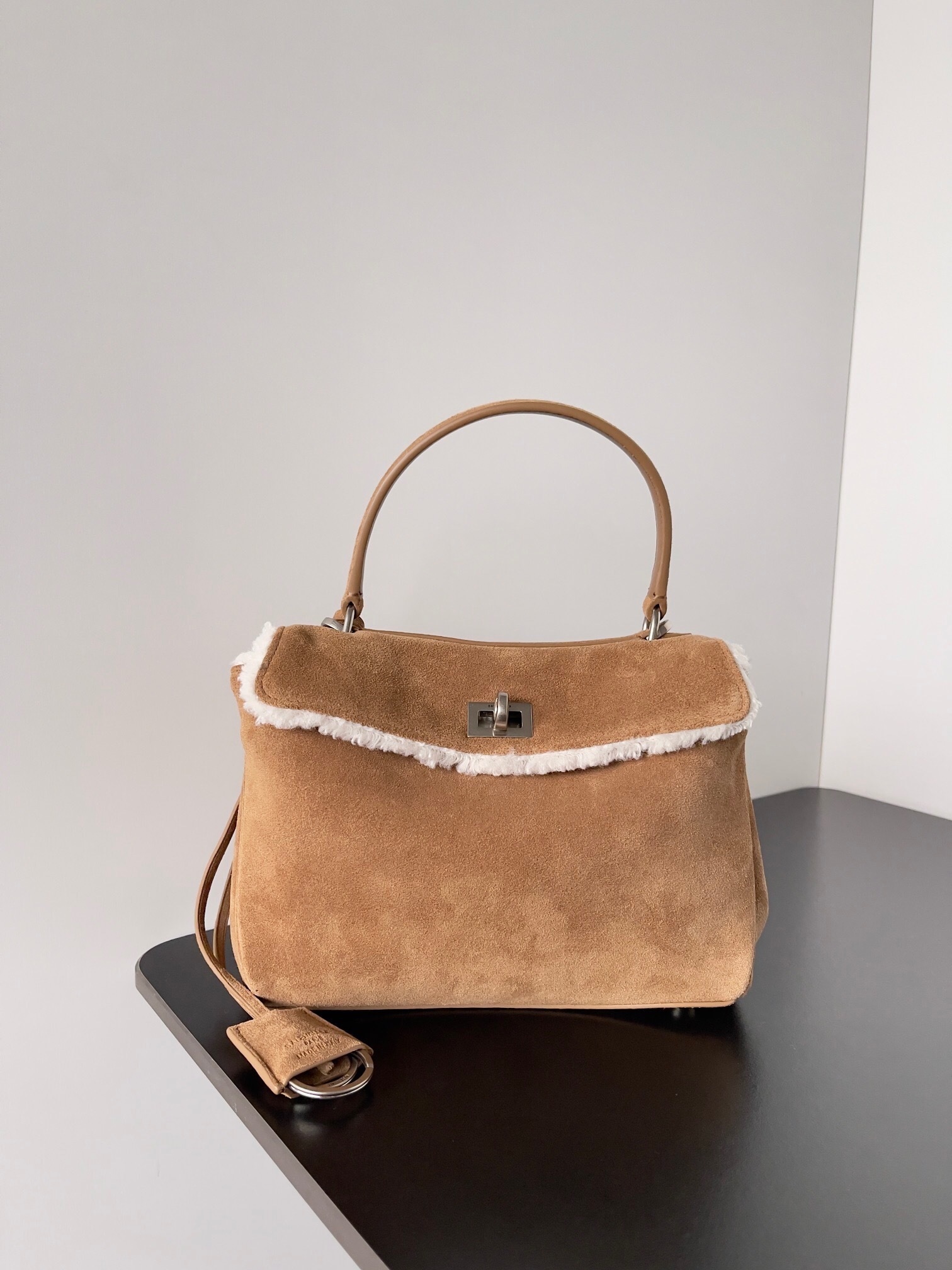 Balenciaga Rodeo handbag crafted from suede and detailed with a white shearling trim