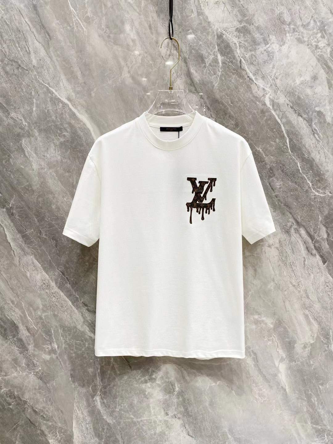 LV T-shirt with a black, "dripping" or "floating" style LV logo on the chest