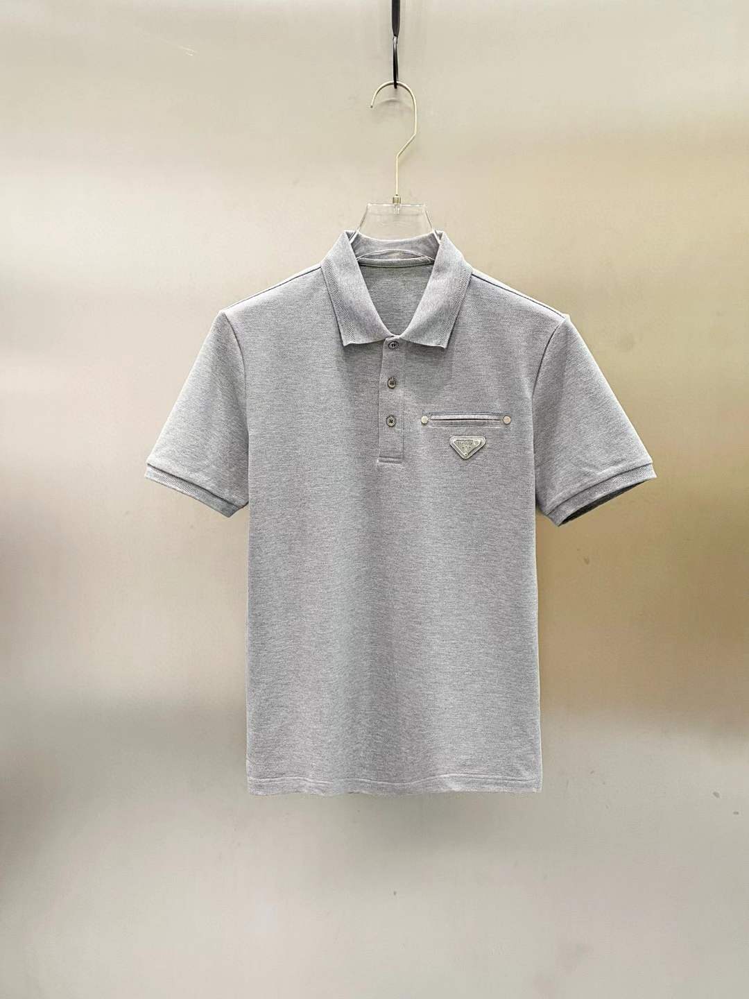 Prada polo shirt with the iconic triangle logo on the chest pocket