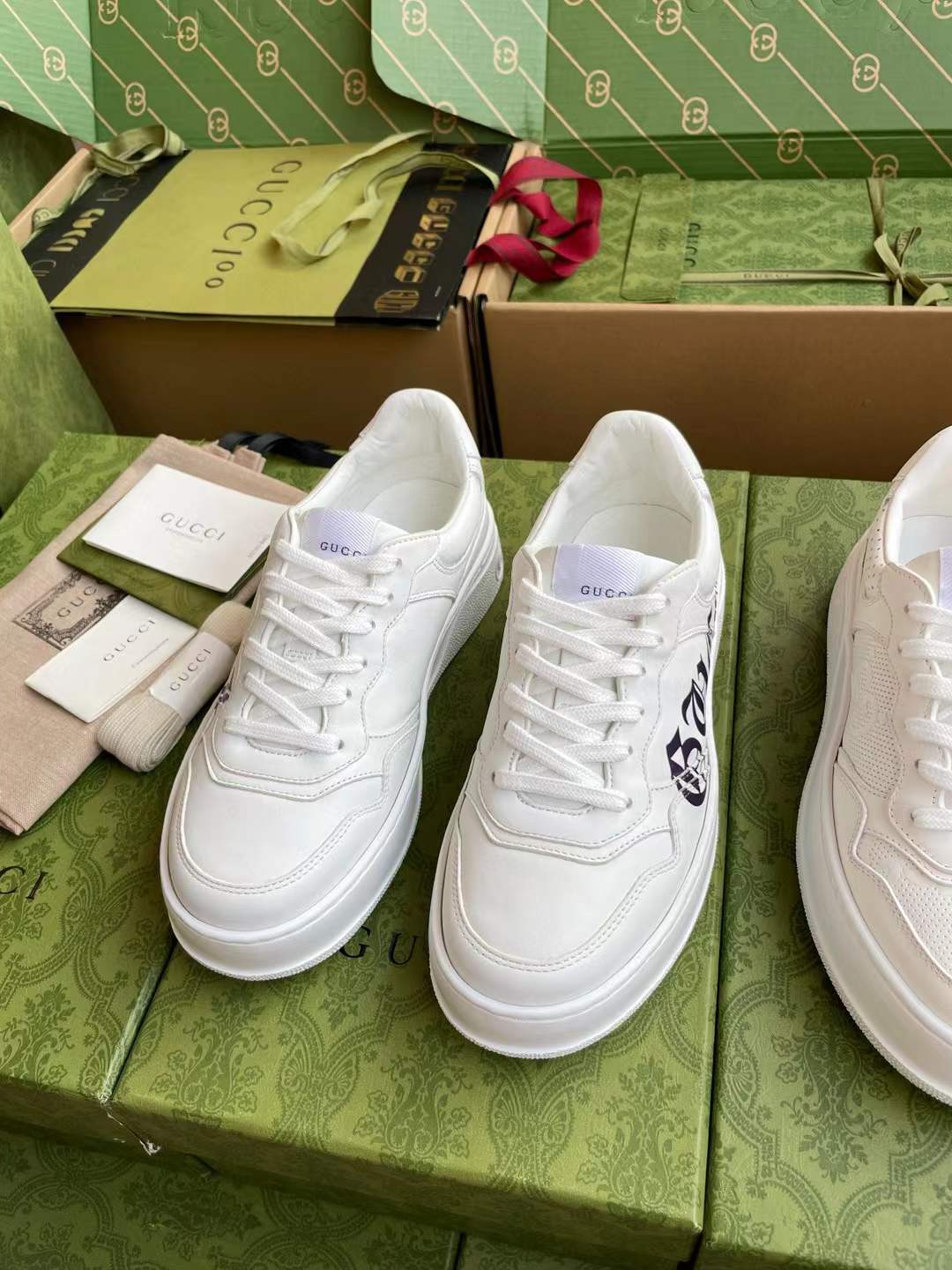 gucci white sneakers with the brand logo engraved on the side