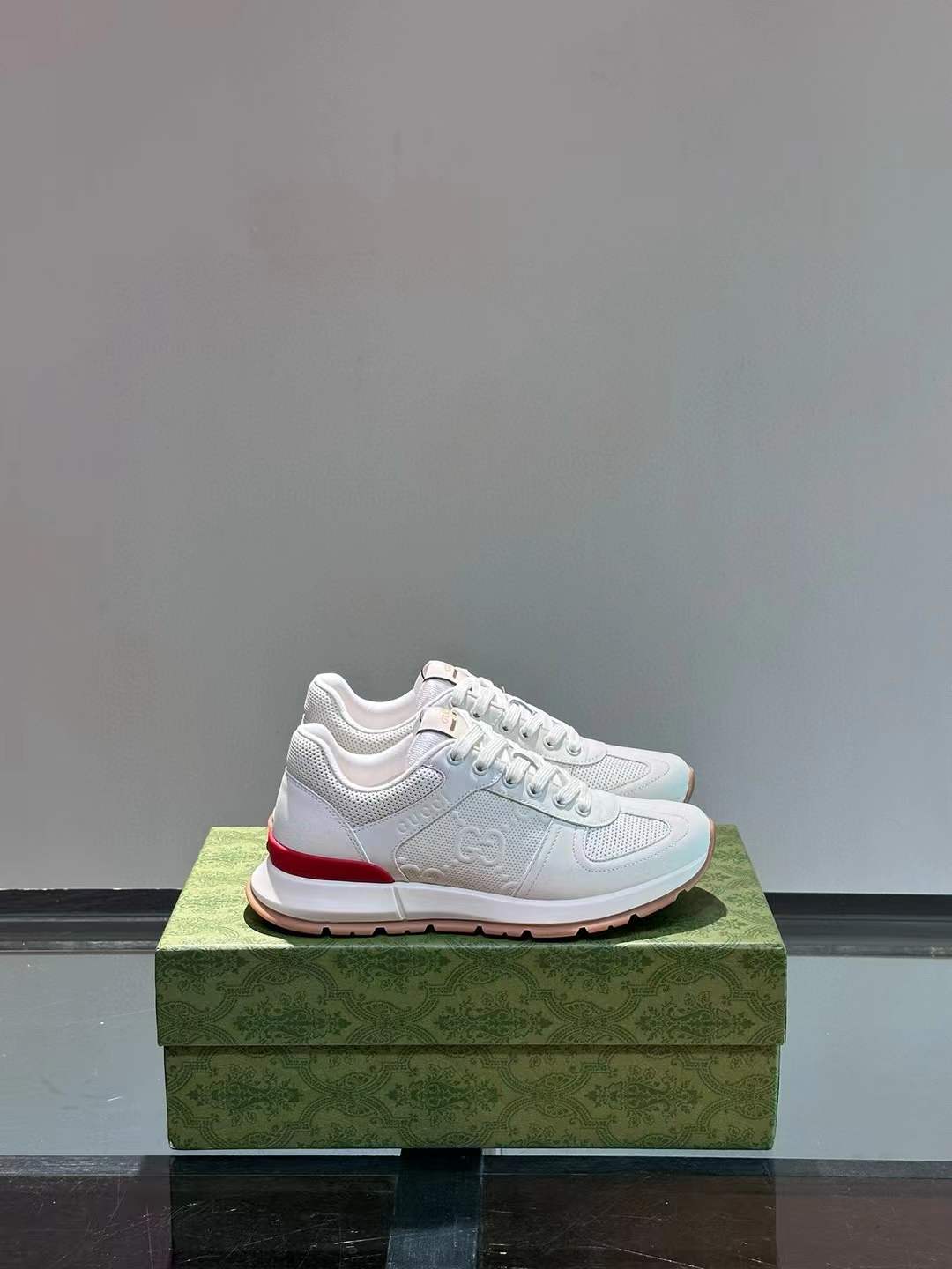 gucci Leather Stamp Sneakers in white with a pink sole and red accent
