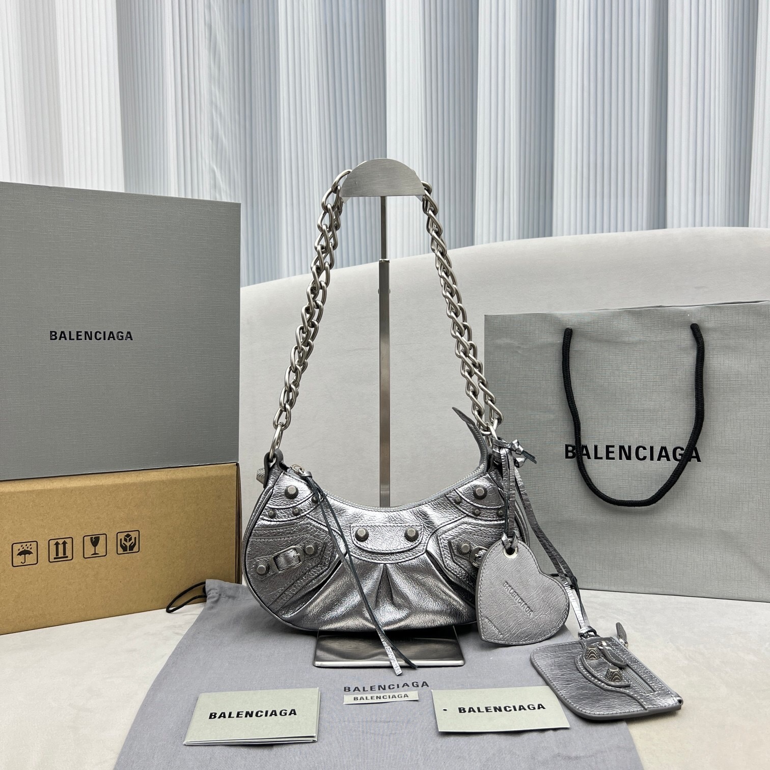 Balenciaga Le Cagole XS shoulder bag in silver crinkled metallic lamb leather with a chain strap