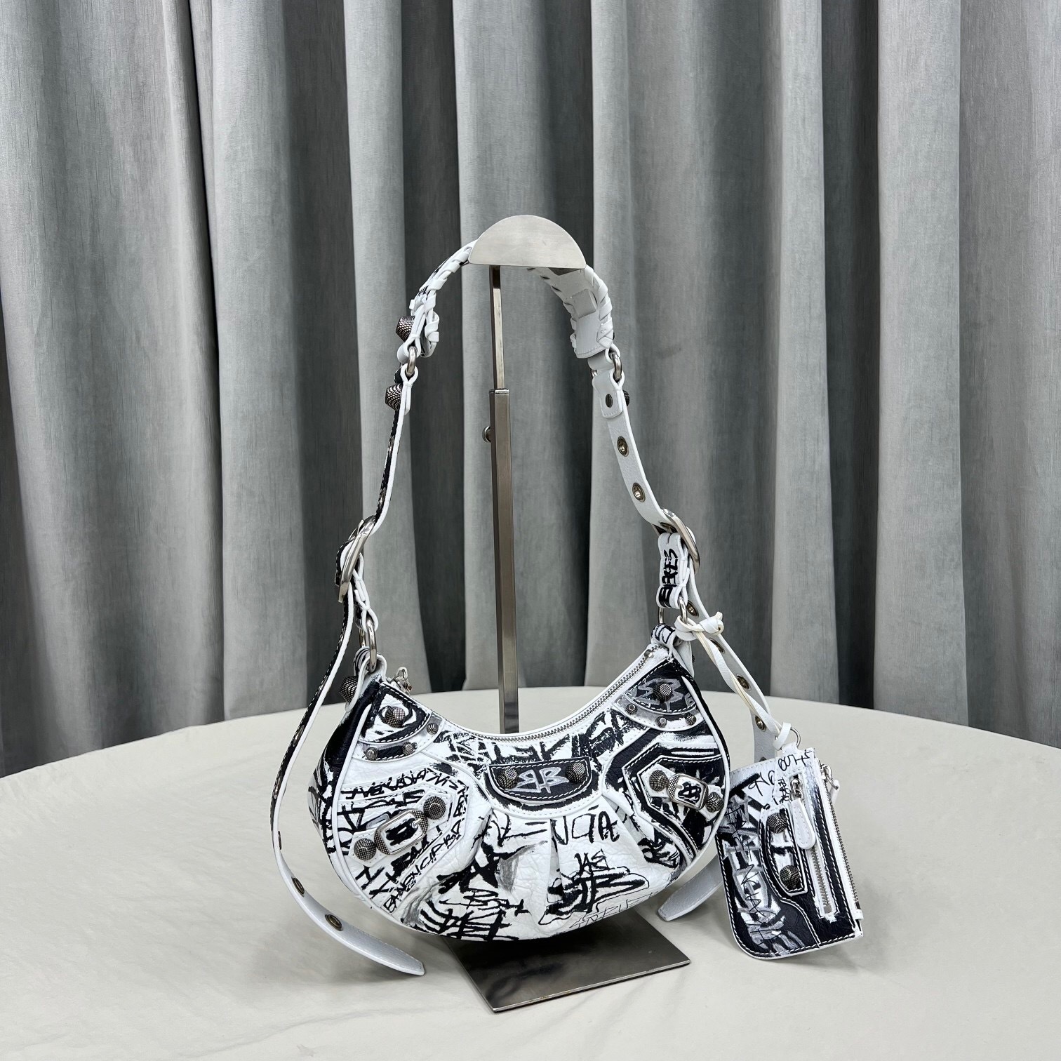 Balenciaga Le Cagole XS shoulder bag in white and black graffiti-print Arena lambskin with aged-silver hardware