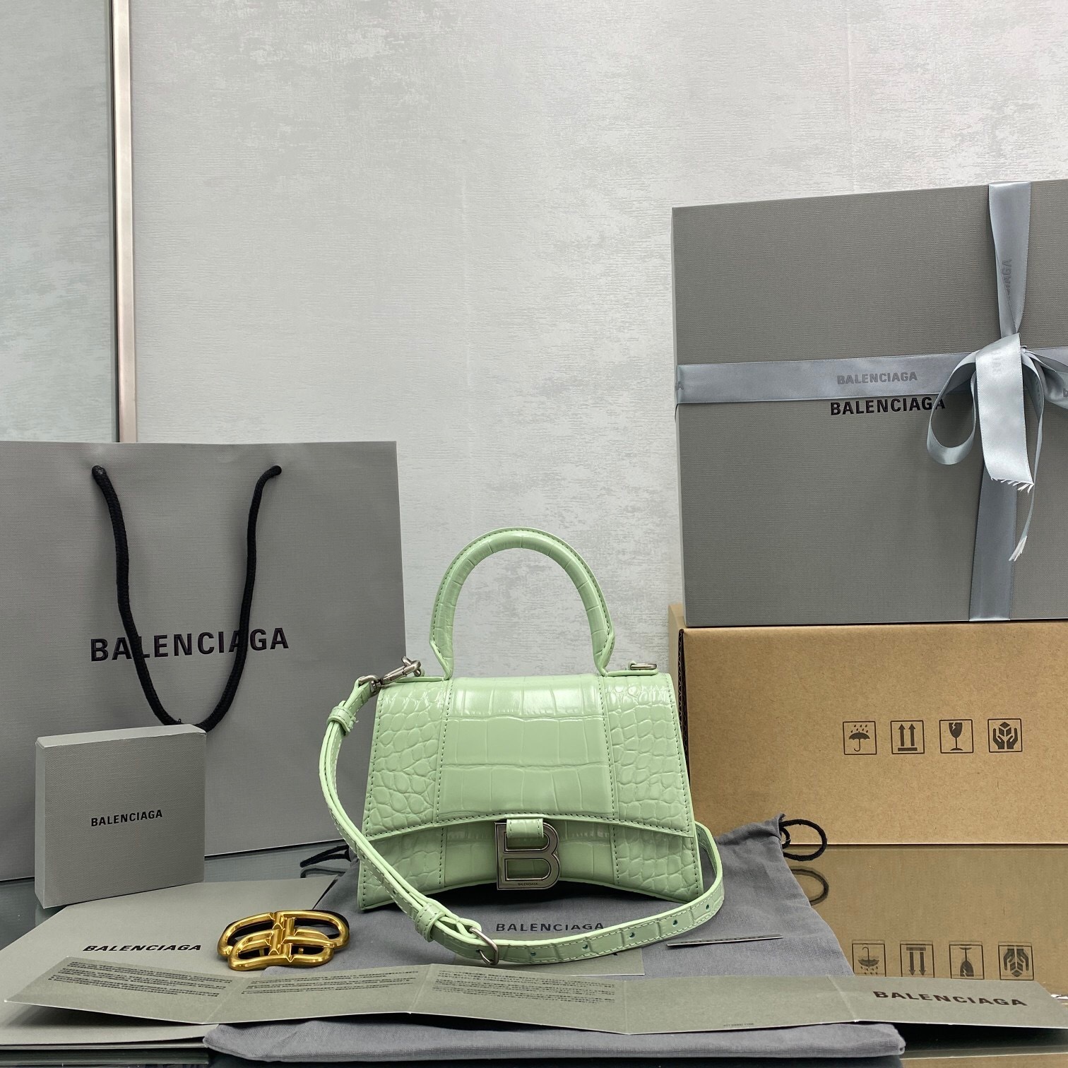 Balenciaga Hourglass XS top handle bag in crocodile-embossed calfskin and a light green color