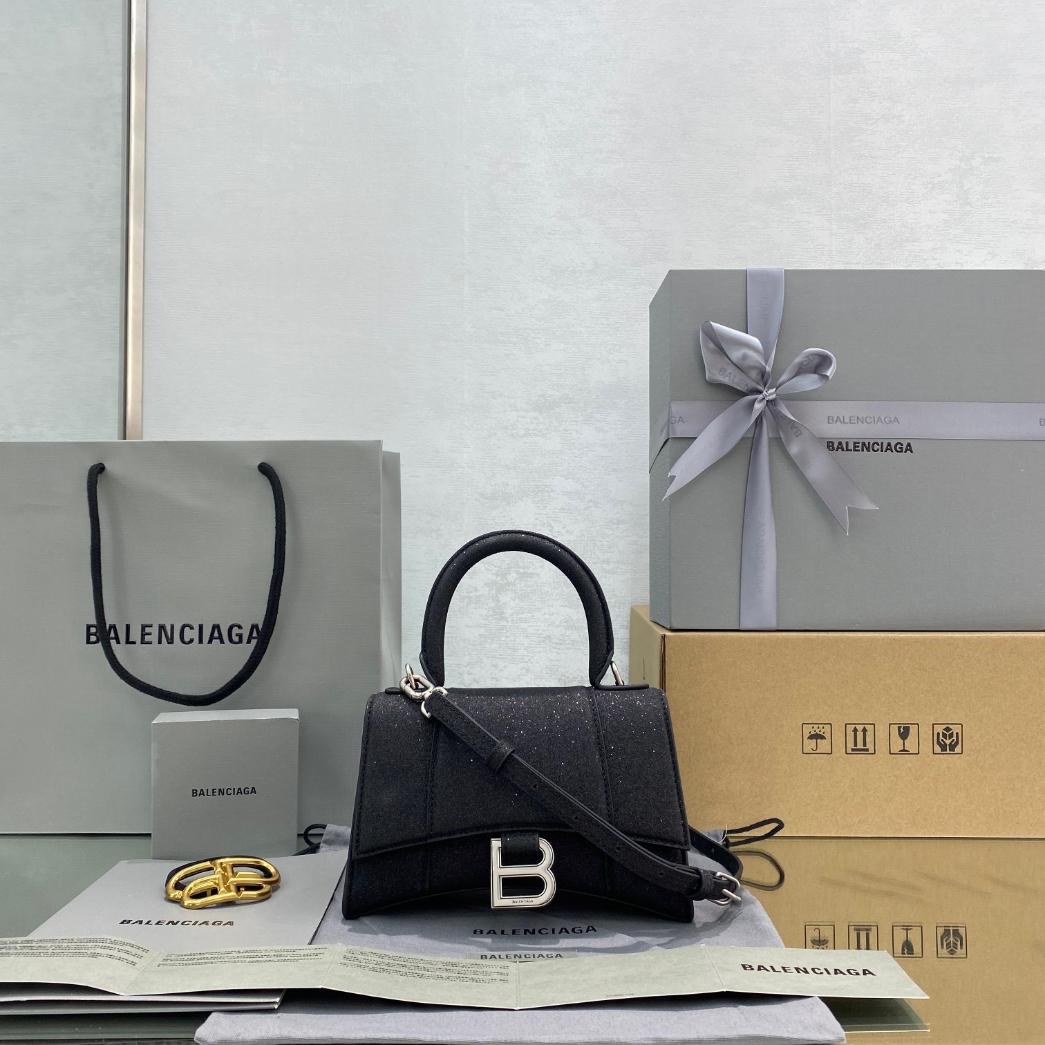 Balenciaga Hourglass top-handle bag in a glitter finish with silver-tone "B" logo hardware black