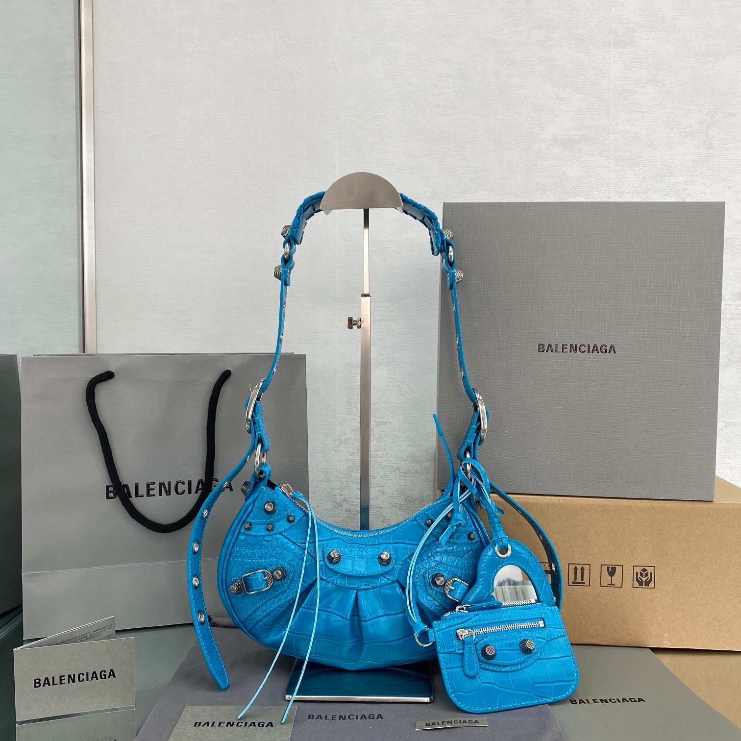 Balenciaga Le Cagole XS shoulder bag in sky blue leather with an embossed crocodile effect