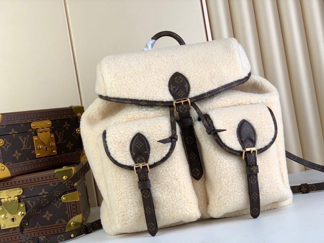 LV SKI Backpack M23384 in cream-colored coated canvas with gold hardware accents