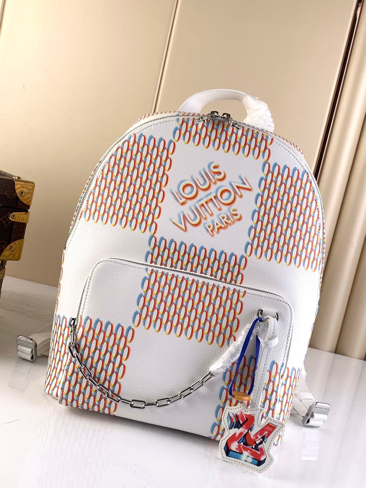 LV Racer Backpack in a white and multi-color Damier Spray pattern
