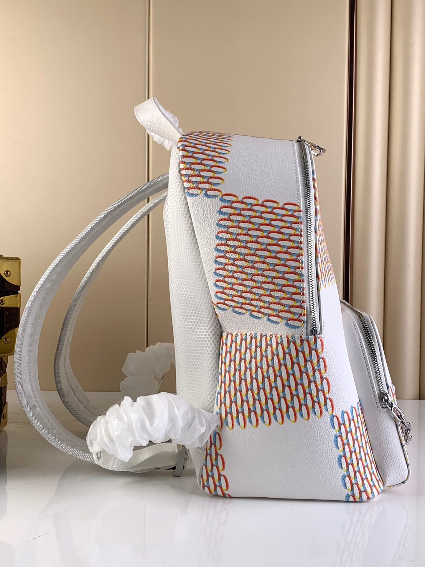 LV Racer Backpack in a white and multi-color Damier Spray pattern