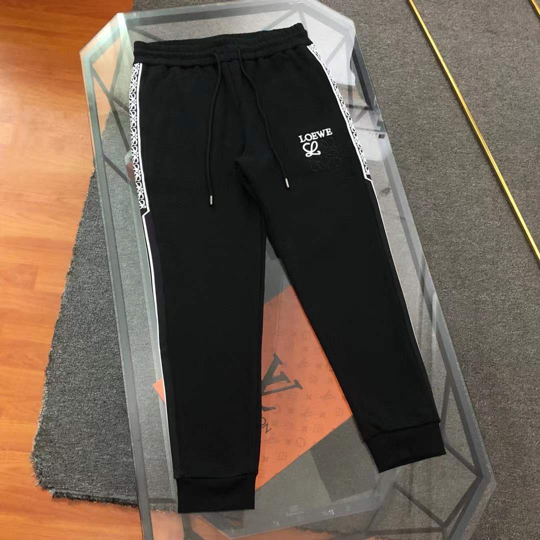 loewe black track pants featuring a "LOEWE" logo and side stripes.