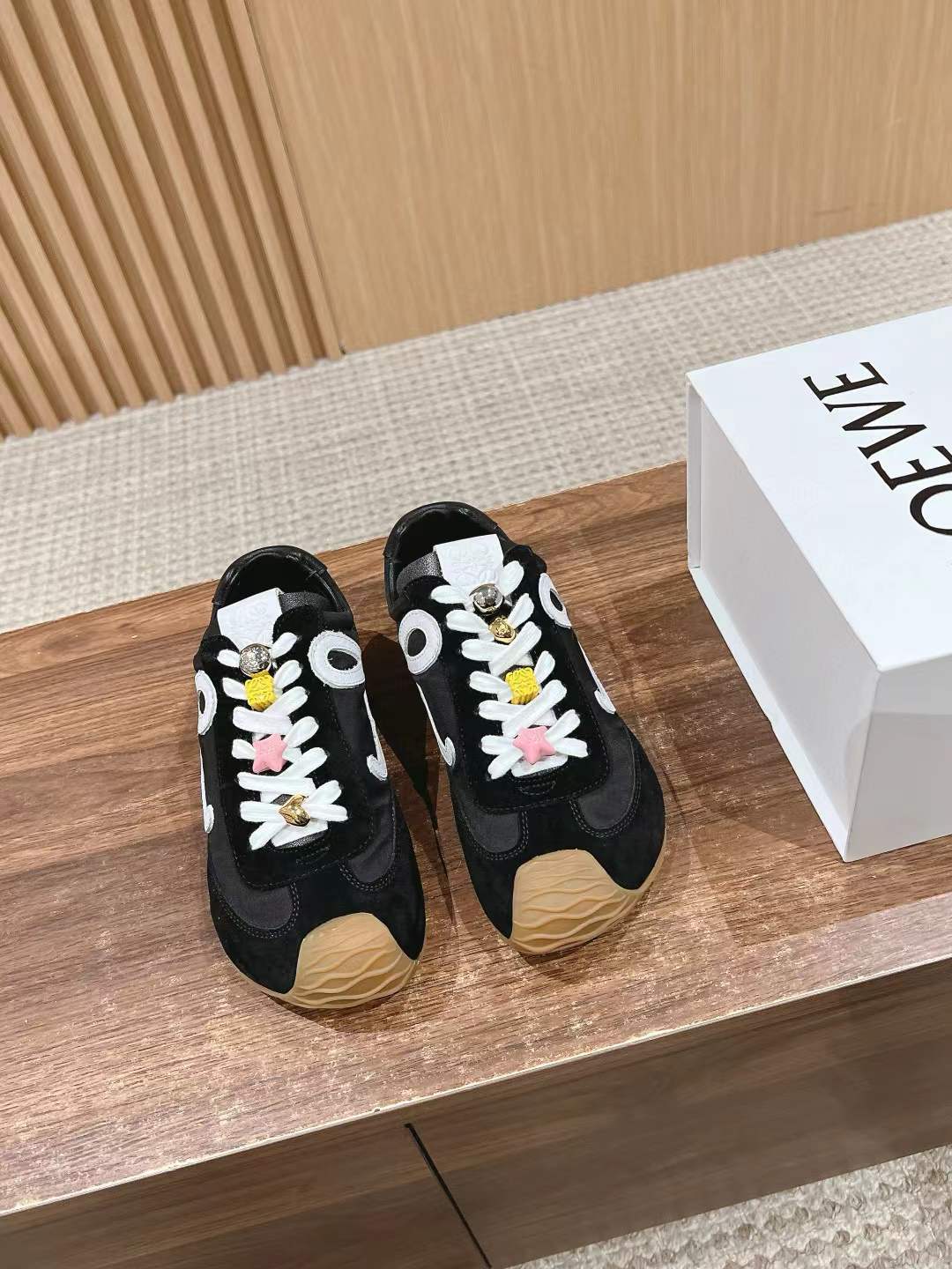 Loewe Ballet Runner 2.0 sneaker in a black and white colorway with colorful lace accessories
