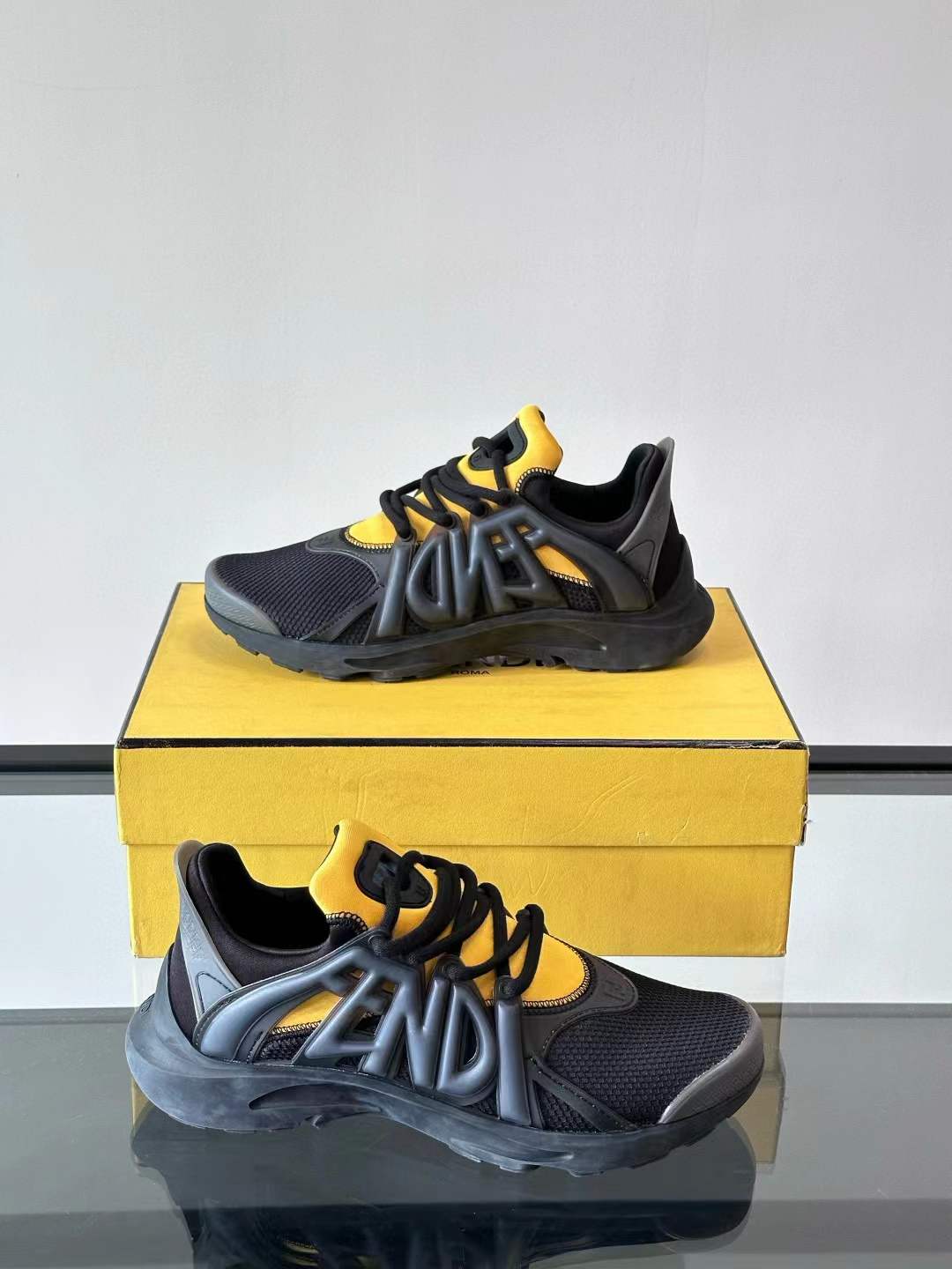 Fendi men's sneaker in a black and yellow colorway with a bold side logo