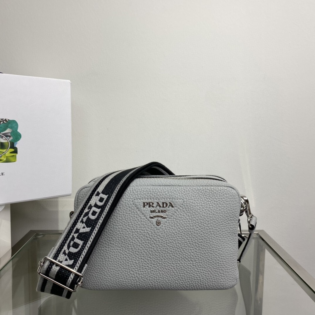 Prada shoulder bag in a clay grey hue with a black and white logo-fabric shoulder strap