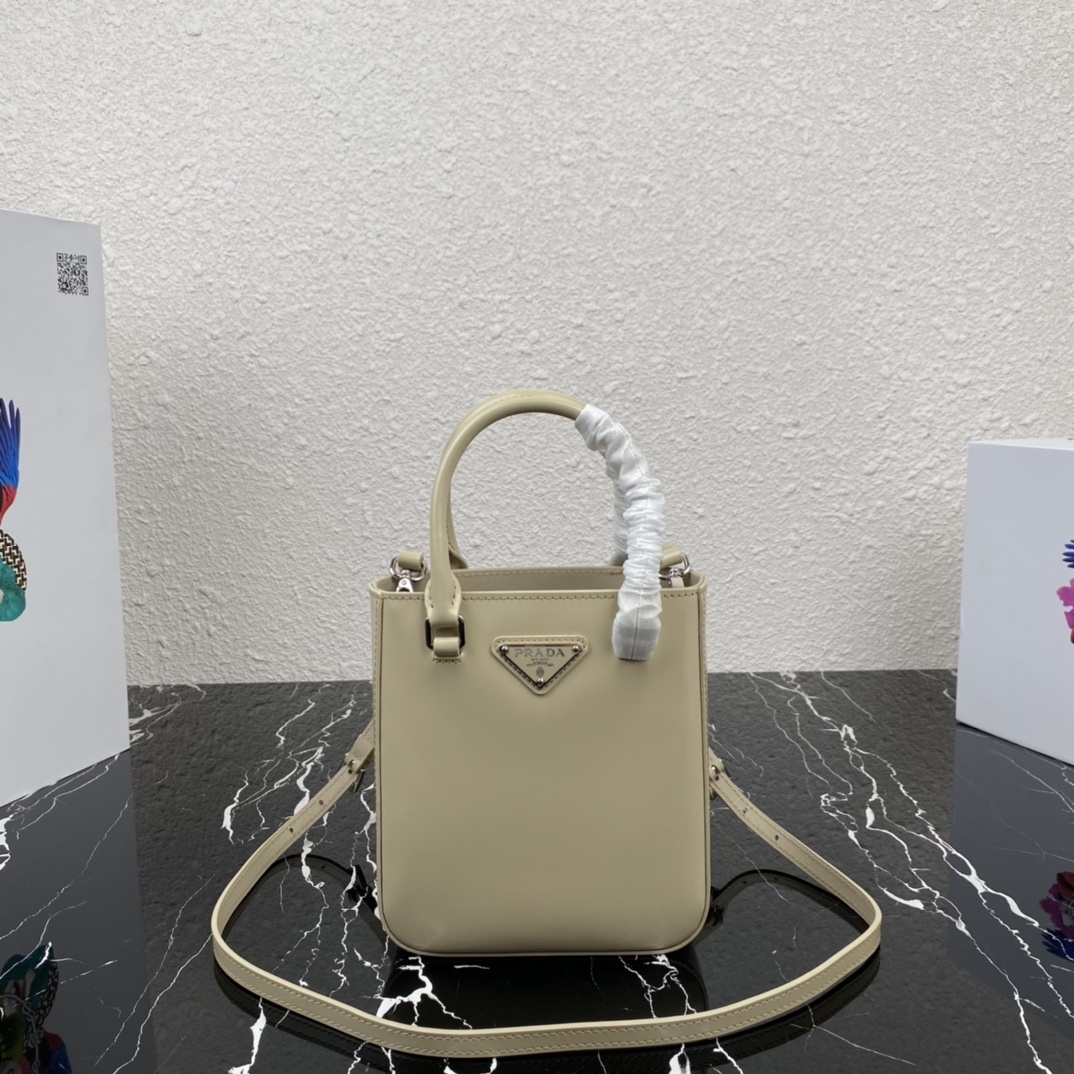 Prada Small Brushed Leather Tote Bag in a light beige or off-white color