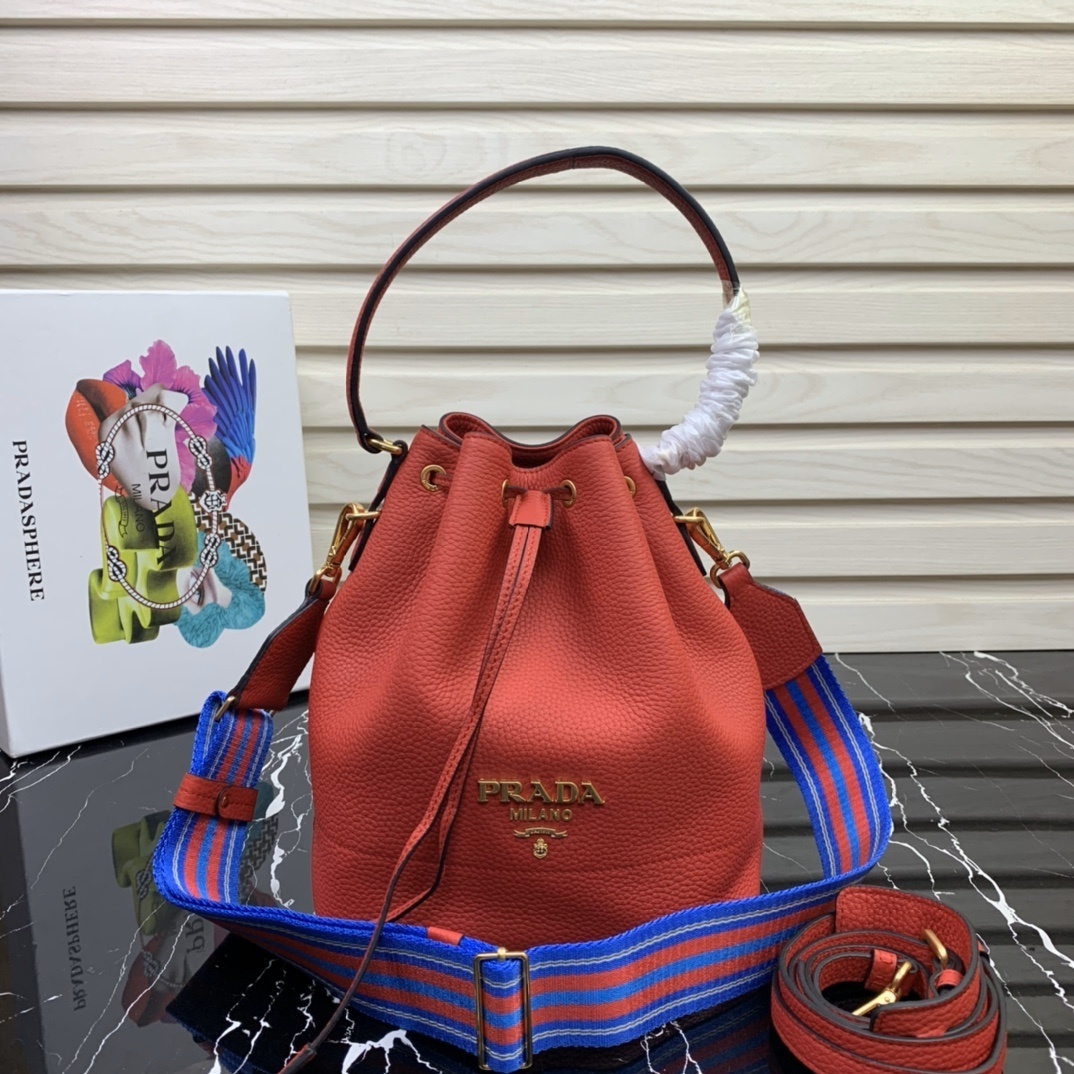 Prada logo bucket bag made from calf leather with a top handle and a detachable