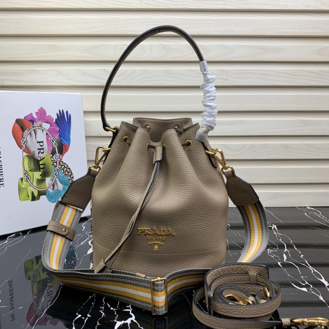Prada Vitello Dino bucket bag in a light brown or gray color