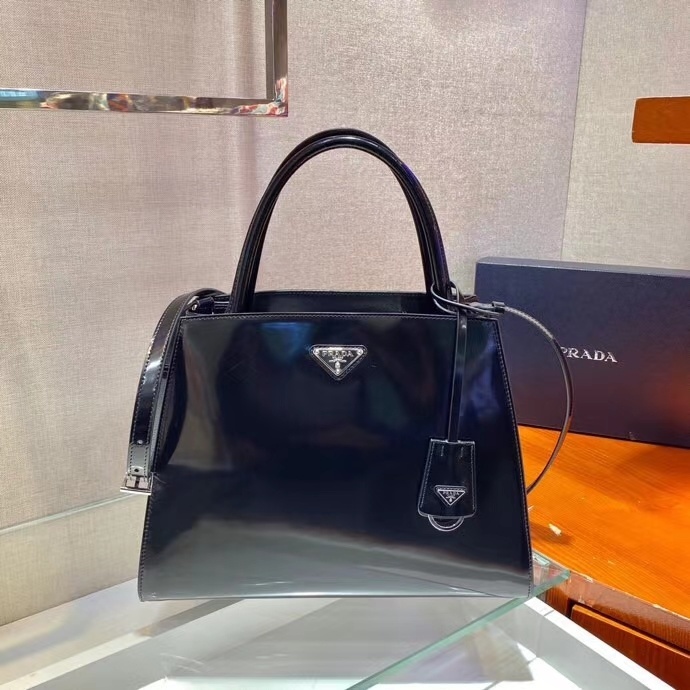 Prada top handle bag black patent leather version of the Galleria or a similar style