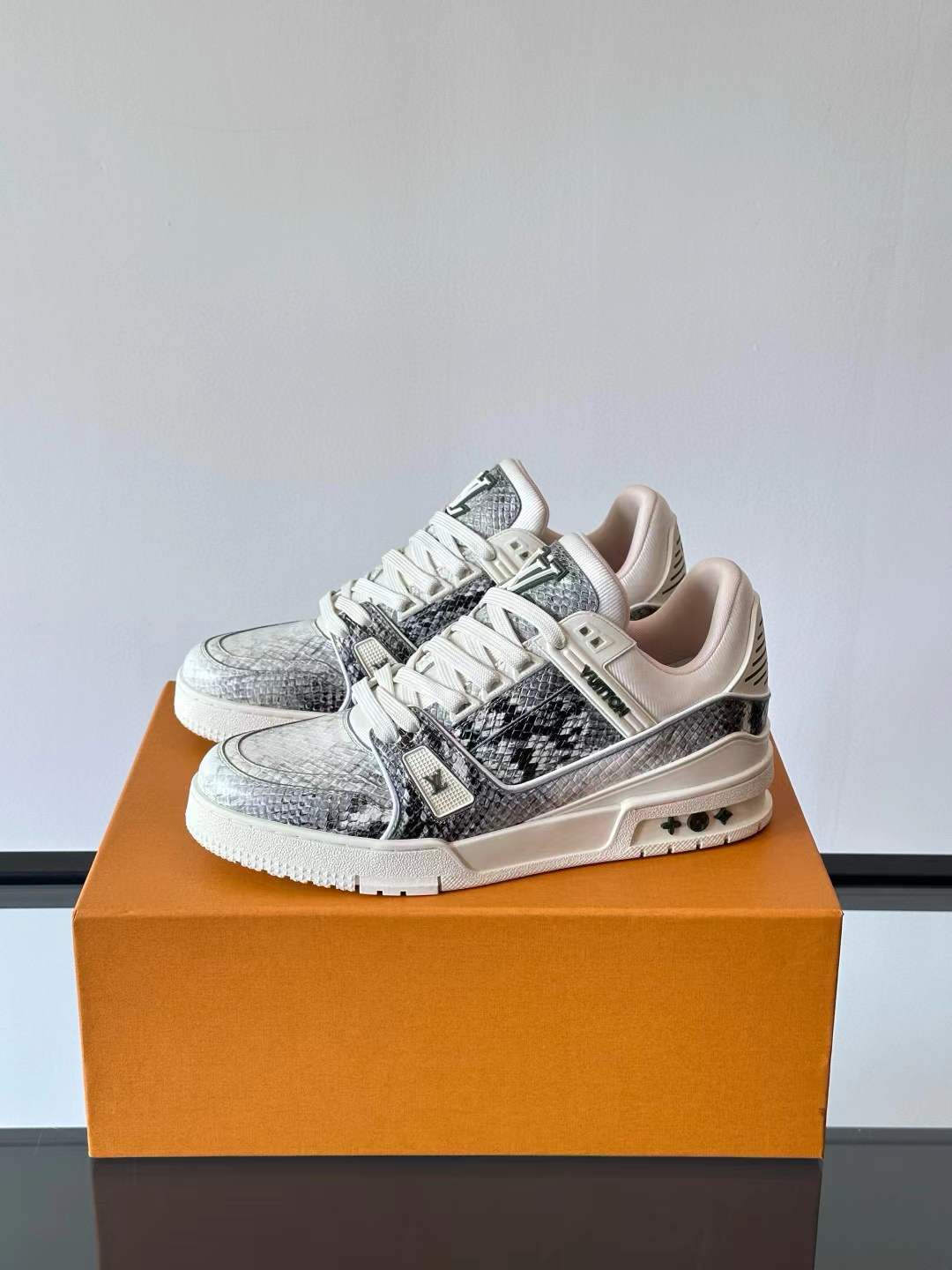 LV Trainer sneaker in a combination of Monogram denim and Monogram-embossed grained calf leather with a white rubber outsole