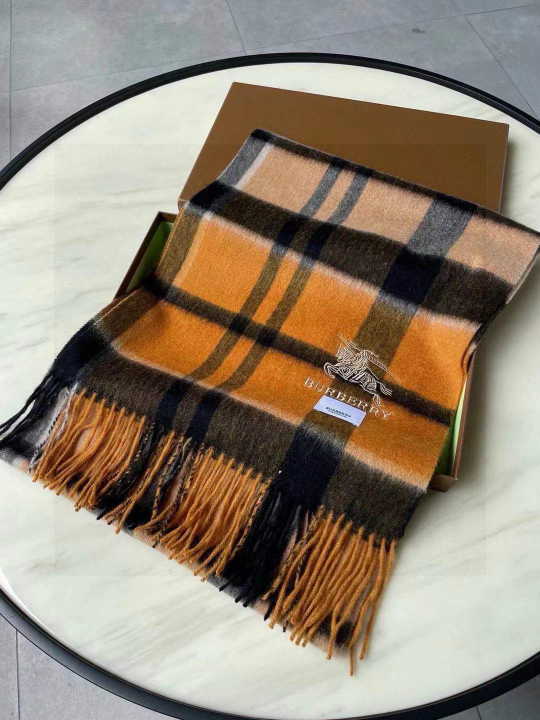 Burberry Check cashmere scarf in a yellow, black, and brown plaid pattern