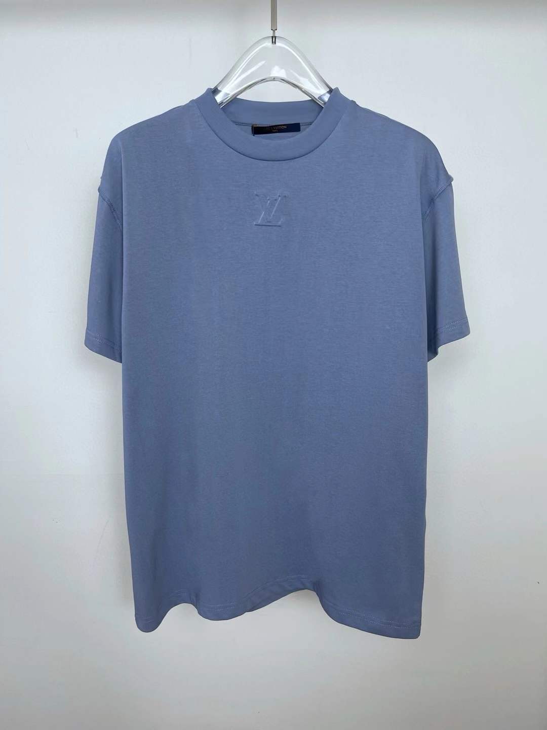 LV Embossed LV T-Shirt in a light or haze blue color.