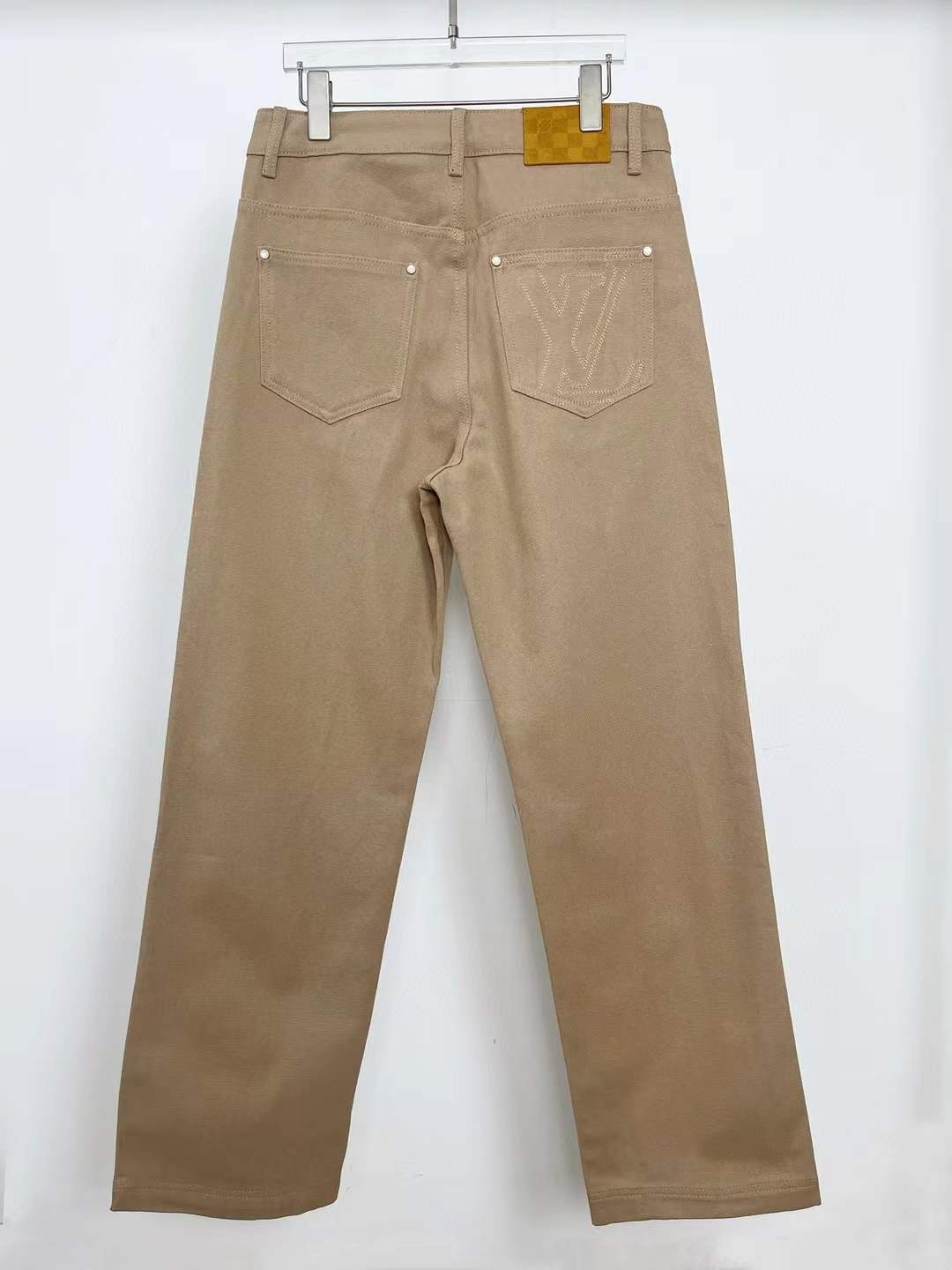 LV Sandro high-rise wide-leg jeans in a khaki or beige color.