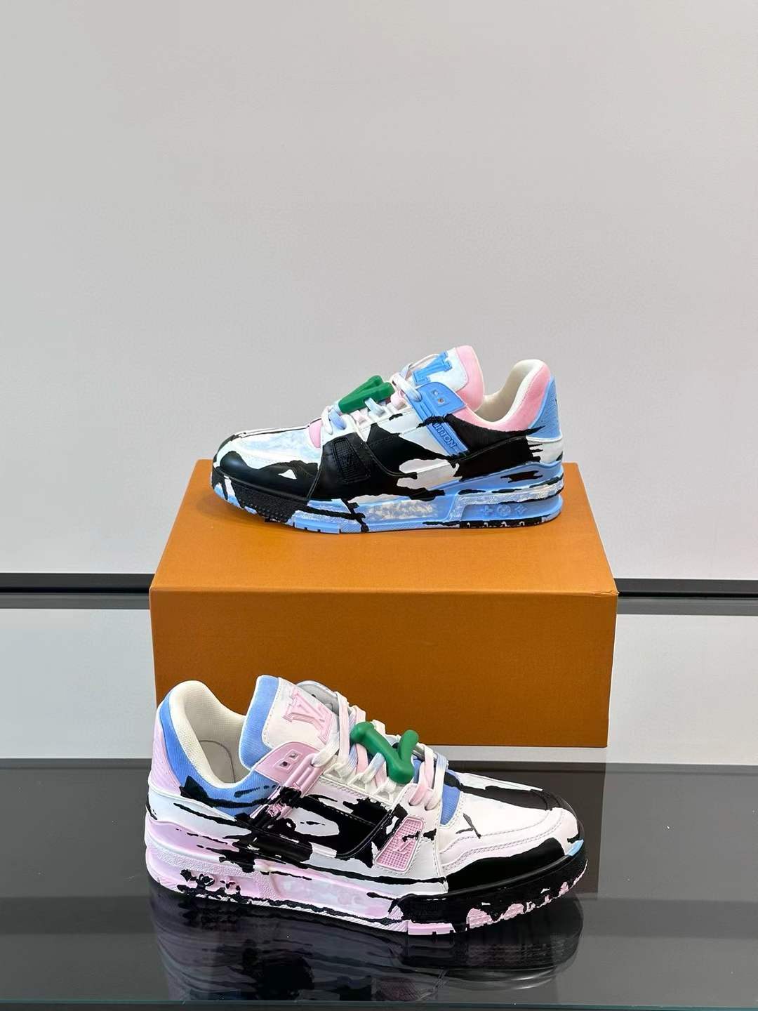 LV  Trainer Artistic Collaboration sneakers featuring a pink and blue graffiti-style design