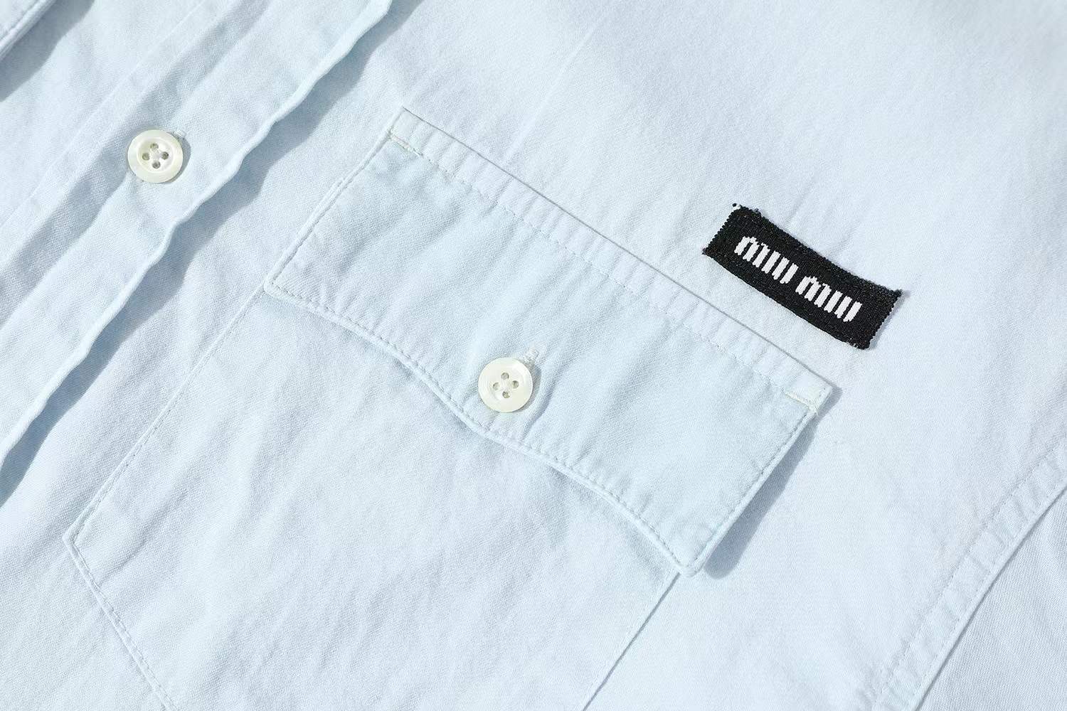 Miu Miu light blue chambray shirt in cotton with a logo patch