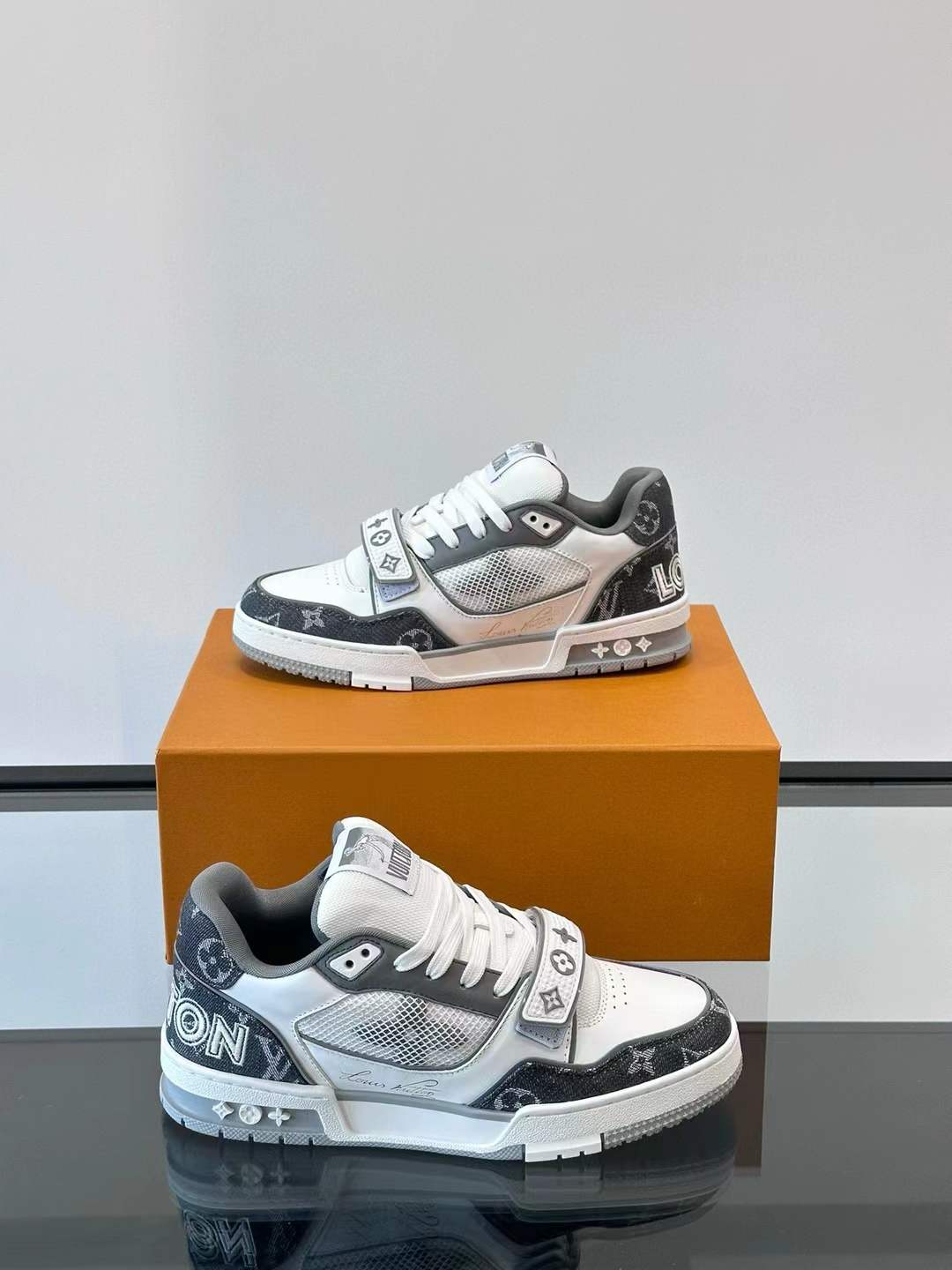 LV Trainer sneaker in Monogram denim and a white and grey/black colorway