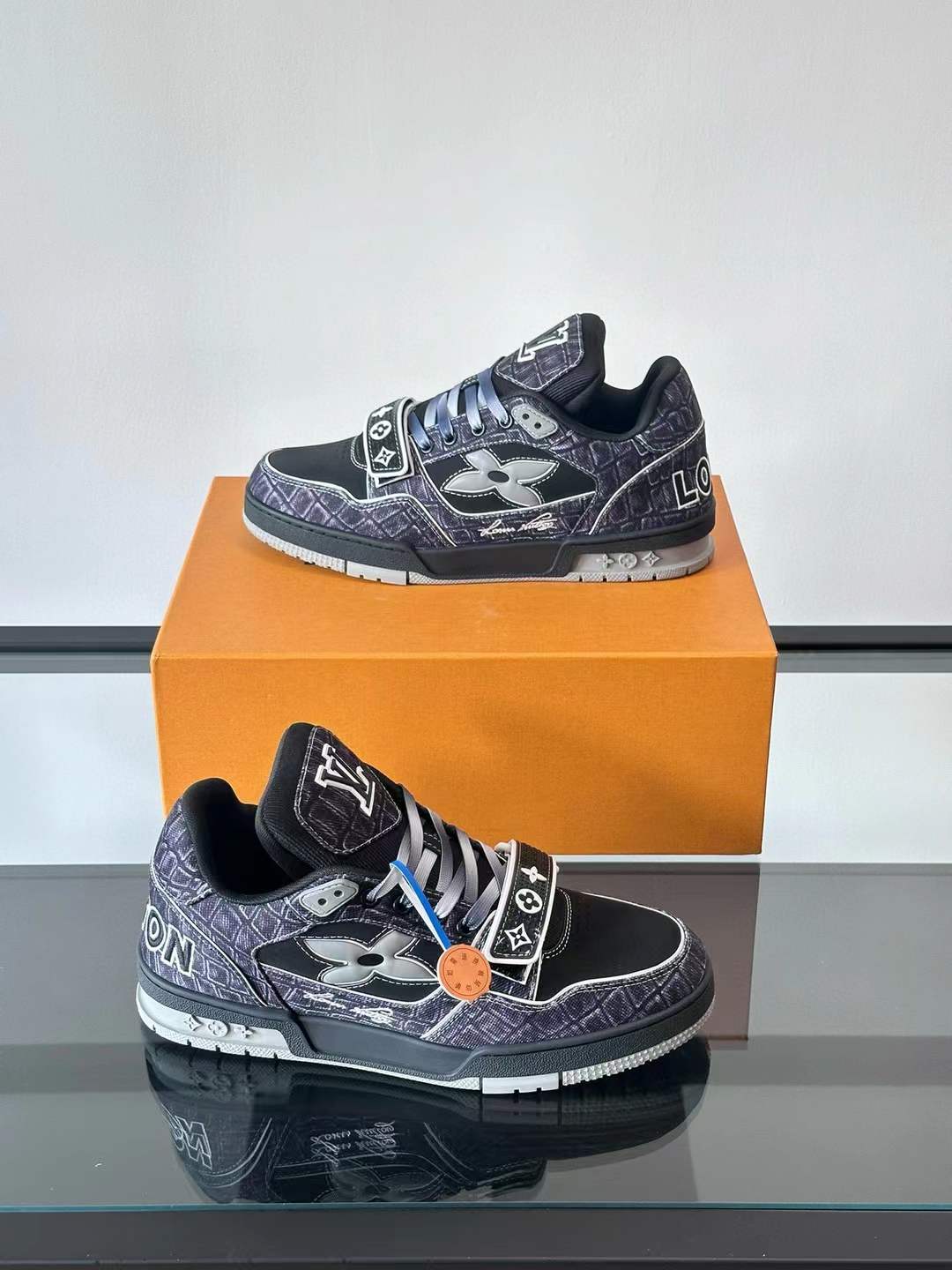 LV Trainer sneaker black upper with a graphic, sketched-style white and purple outline design