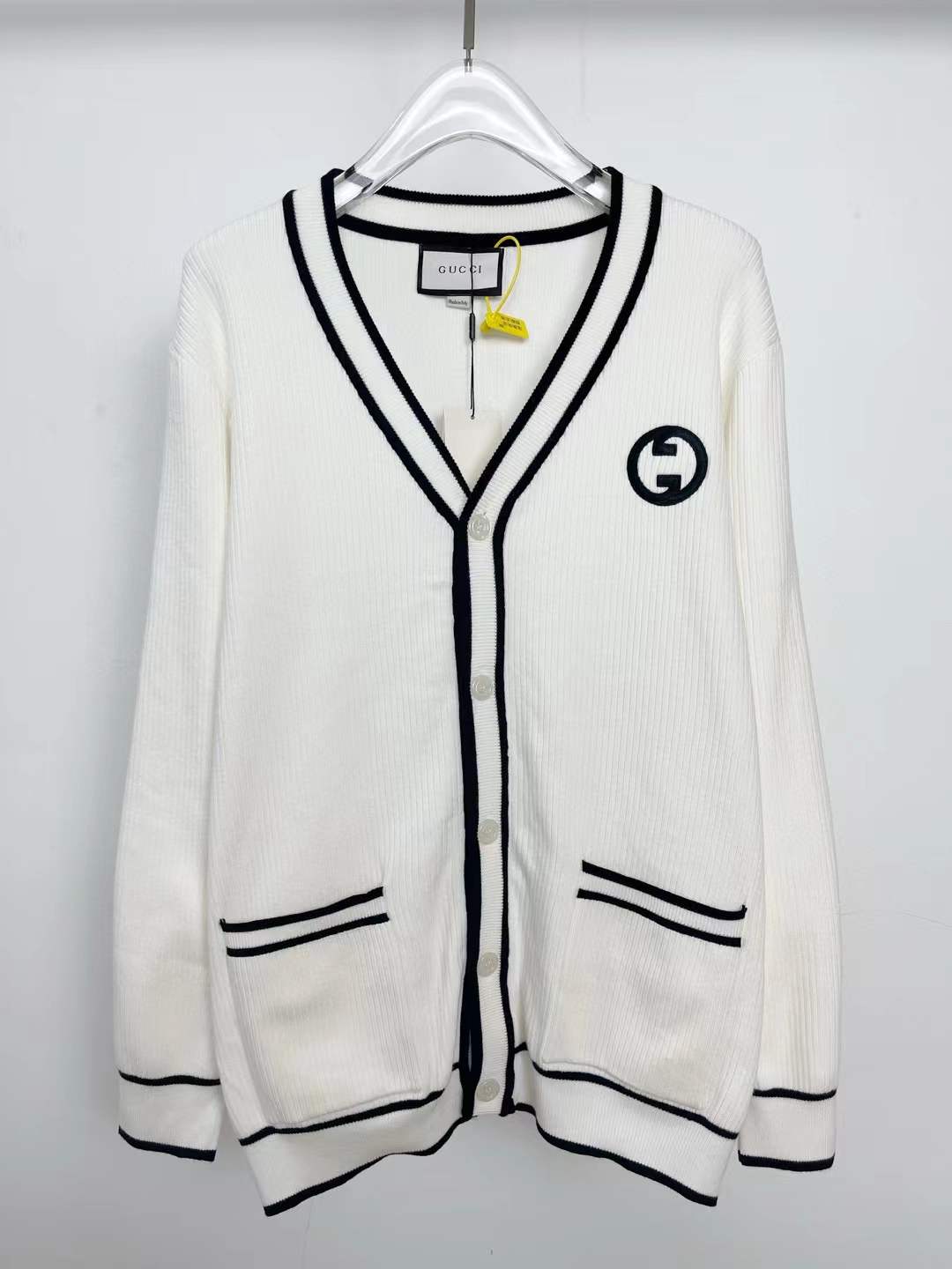Gucci cotton and wool cardigan with contrasting blue trims and the iconic interlocking G patch on its chest
