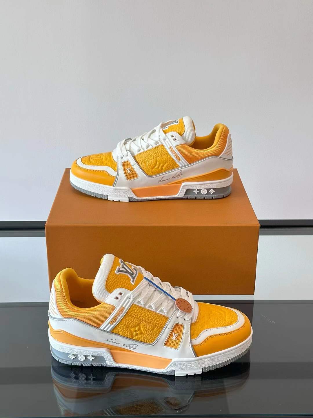 LV Trainer sneaker in yellow and white, featuring Monogram denim and grained calf leather accents