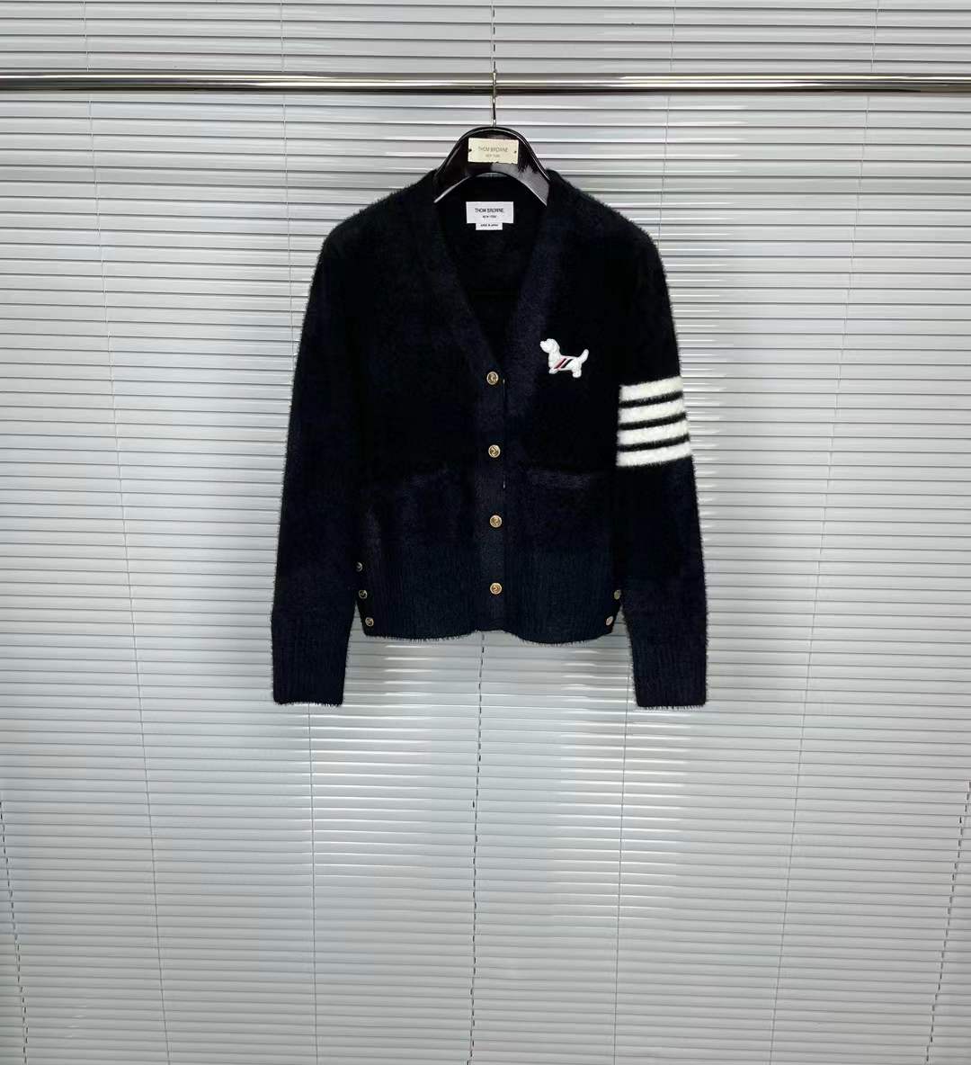 Thom Browne navy blue cotton V-neck cardigan featuring the signature 4-Bar stripe on the sleeve and the Hector motif.