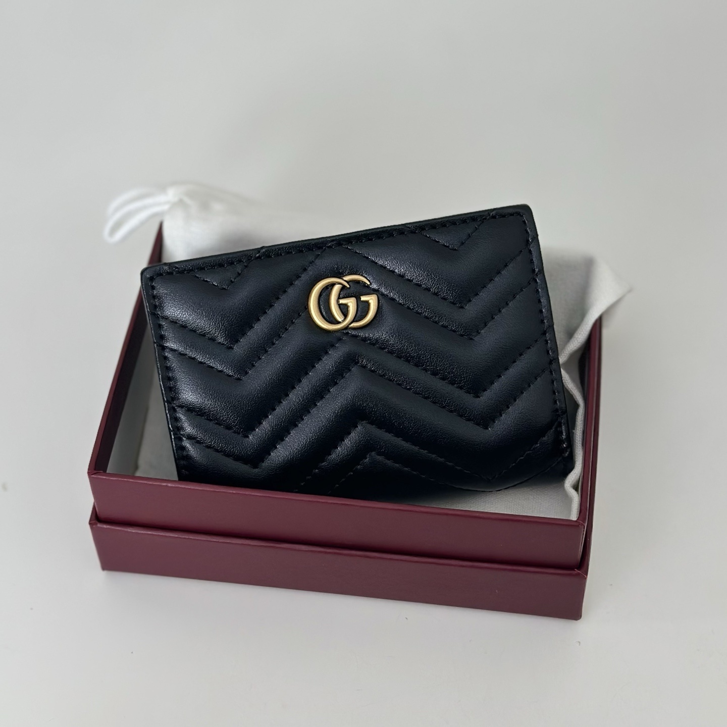 Gucci GG Marmont matelassé black leather wallet with the signature Double G hardware