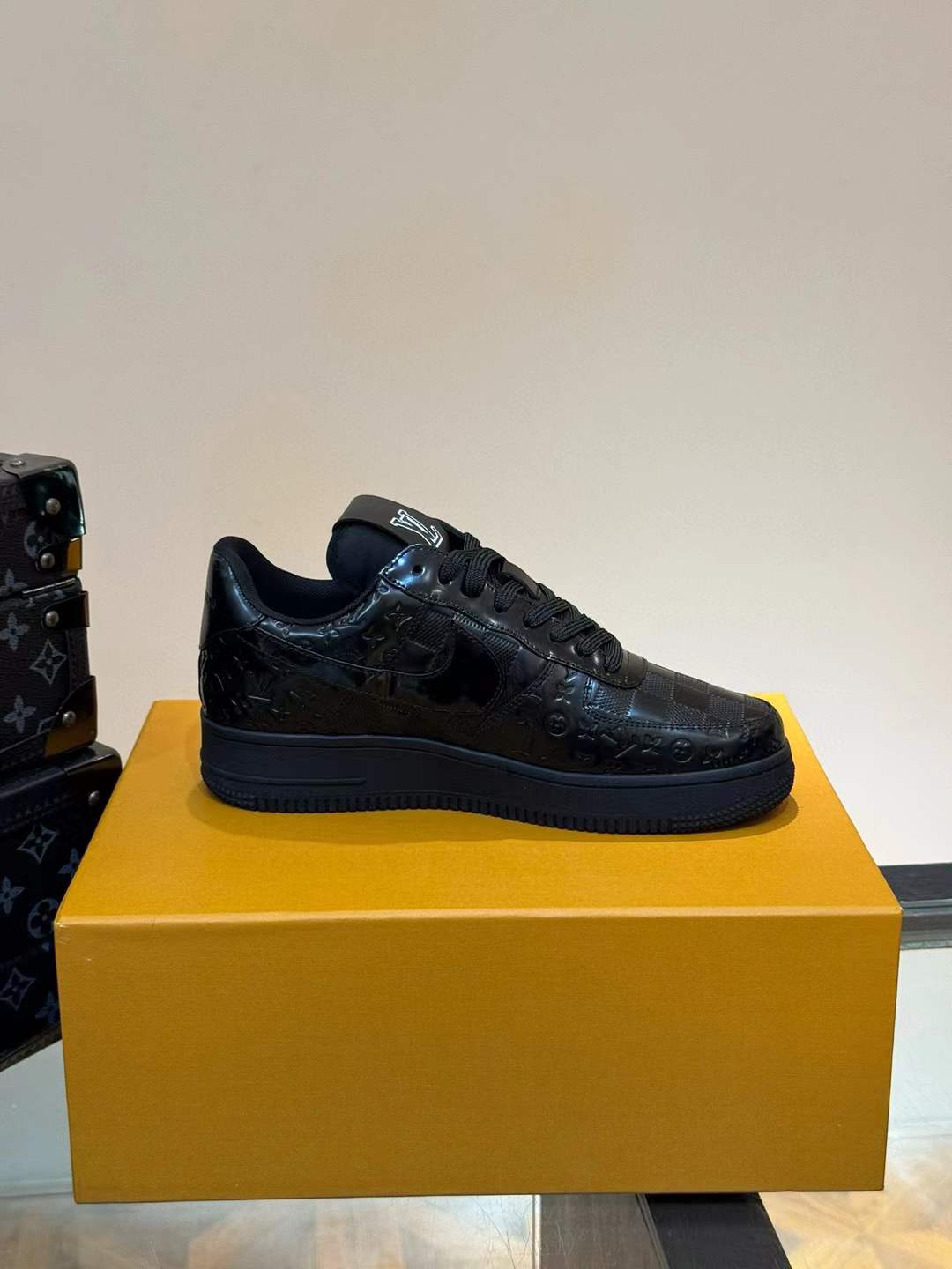 LV x Nike Air Force 1 Low sneakers in black with the iconic monogram pattern stamped into the leather