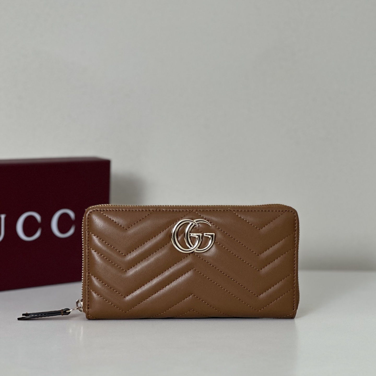 Gucci GG Marmont zip-around wallet in brown matelassé chevron leather with silver-toned hardware