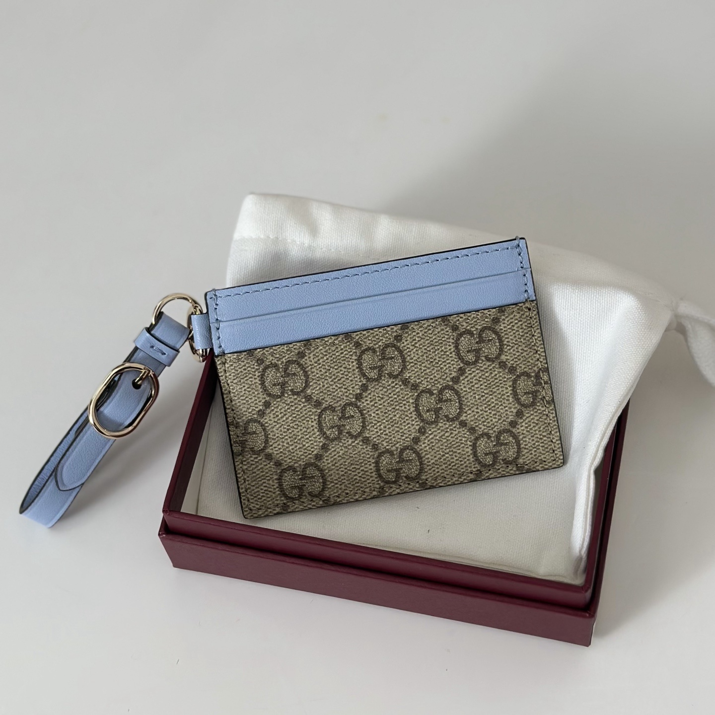 Gucci GG Emblem card case with strap in GG canvas and blue leather trim