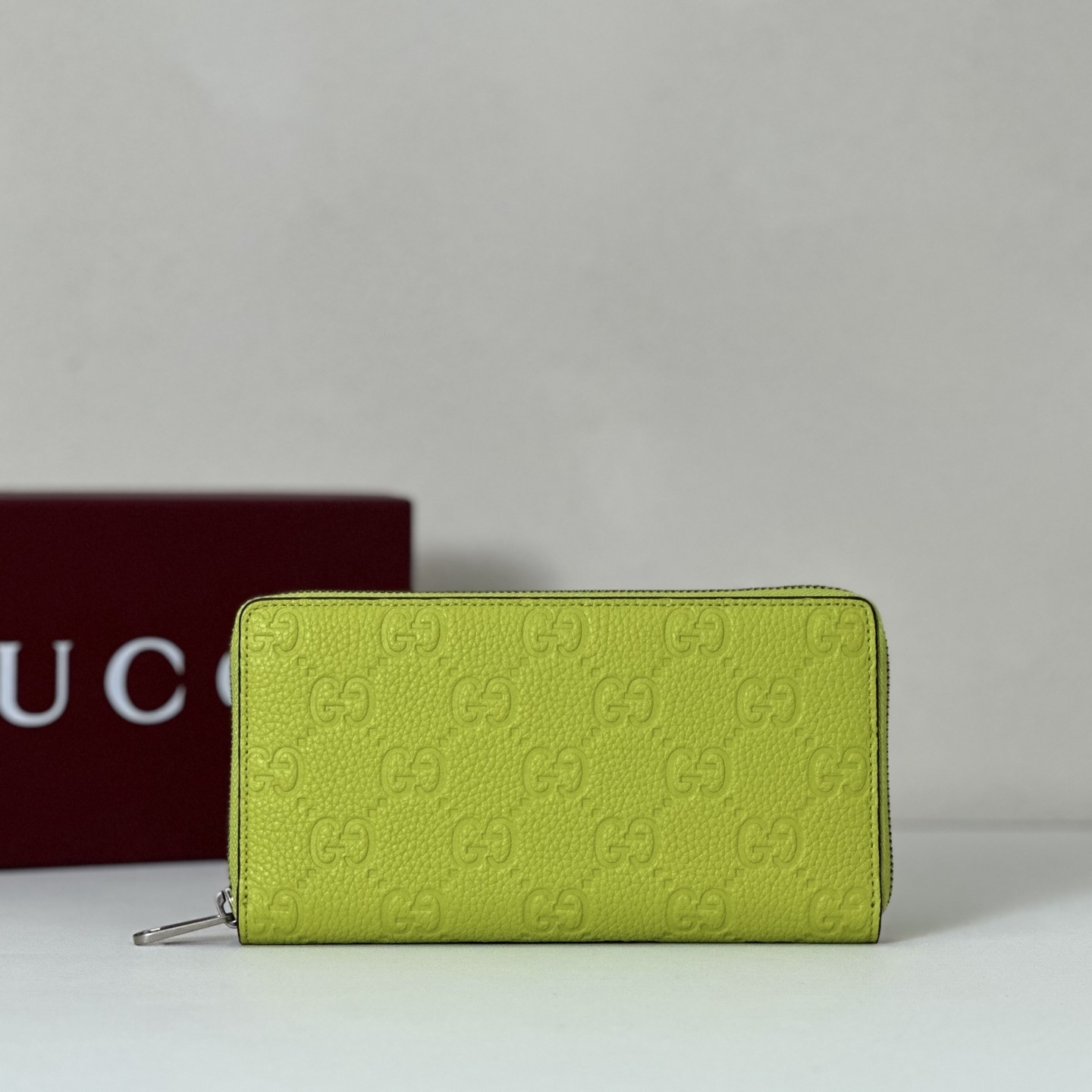 Gucci Signature zip-around wallet in a neon green/lime color with the embossed GG pattern
