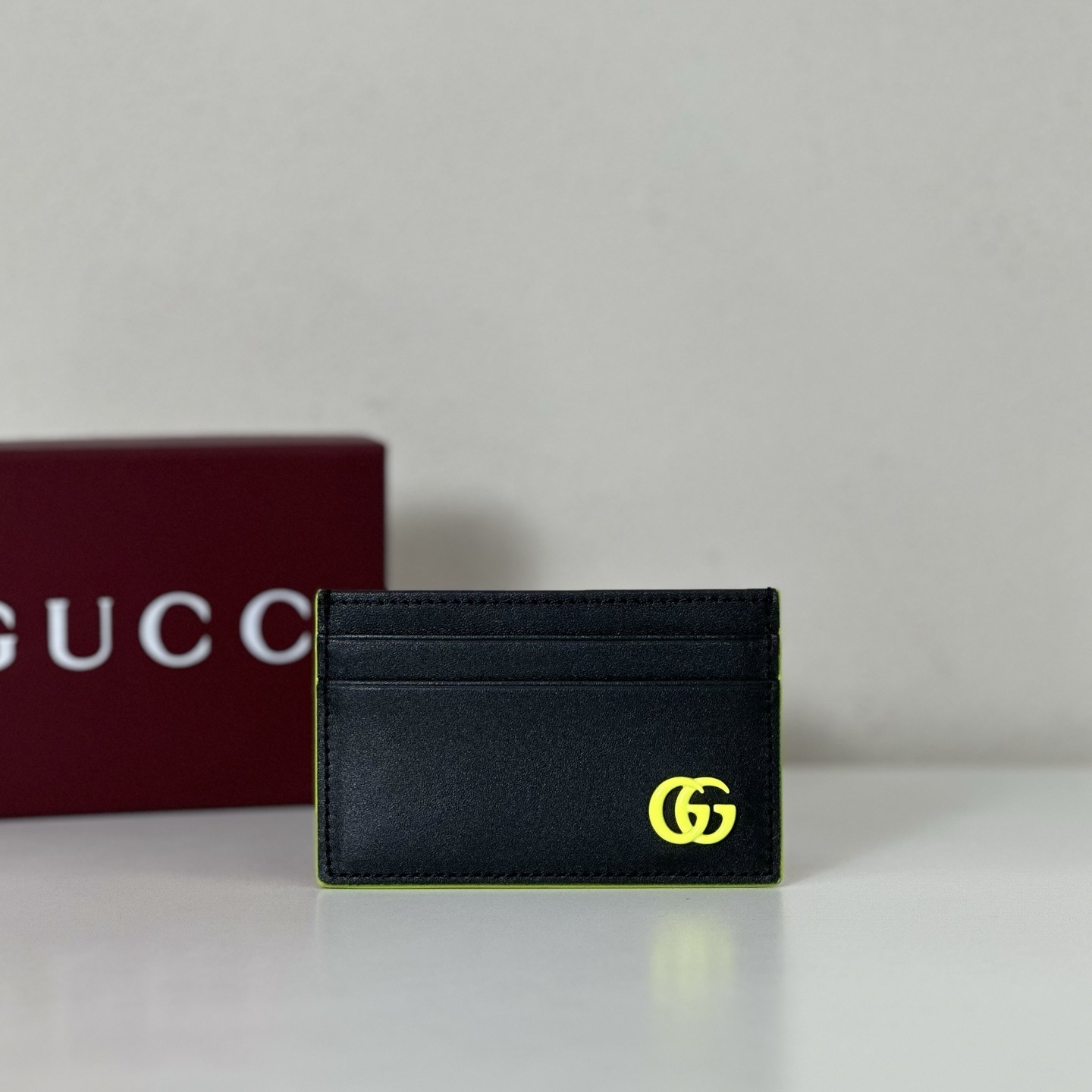 Gucci GG Marmont card case in black leather with a yellow logo