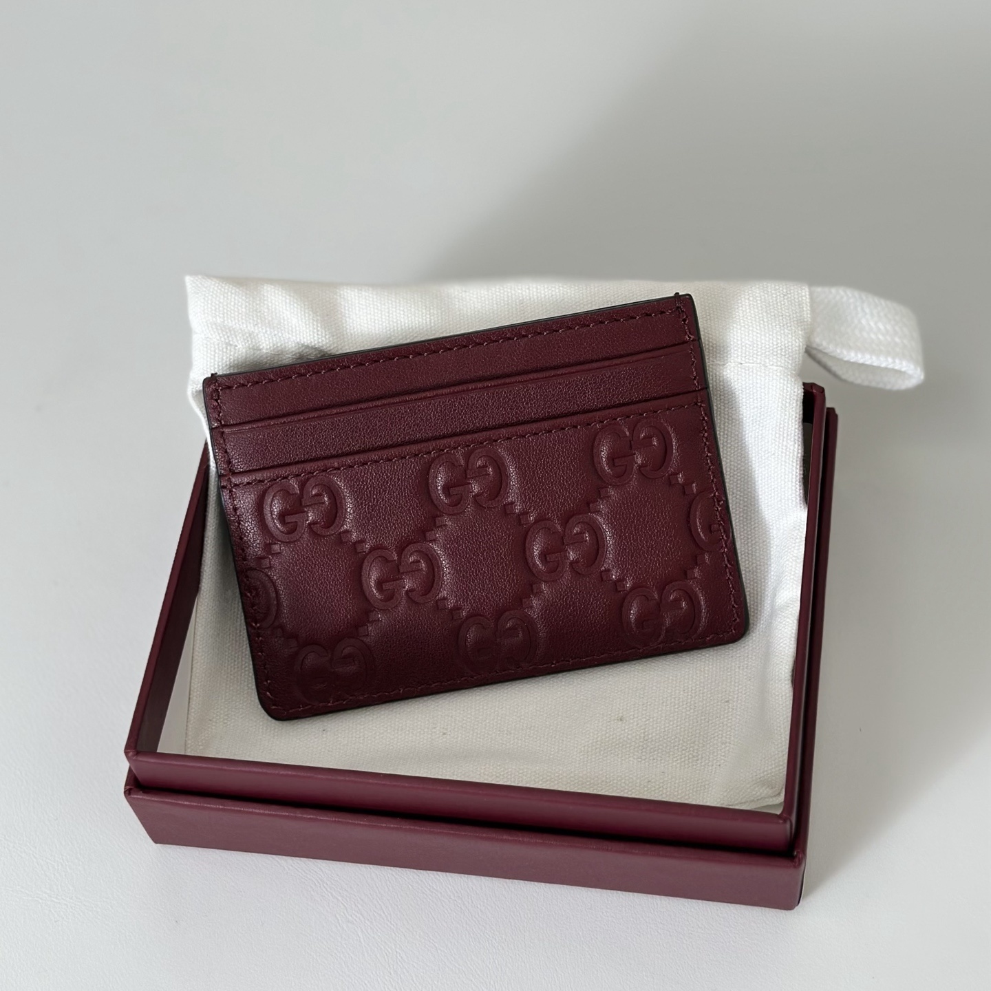 Gucci GG Microguccissima leather card holder in a burgundy or red color