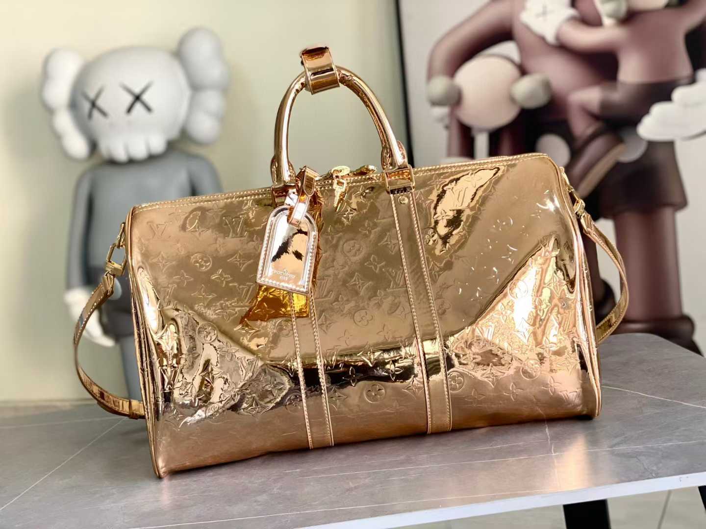 lv Monogram Miroir Keepall 55 travel bag in a gold vinyl finish