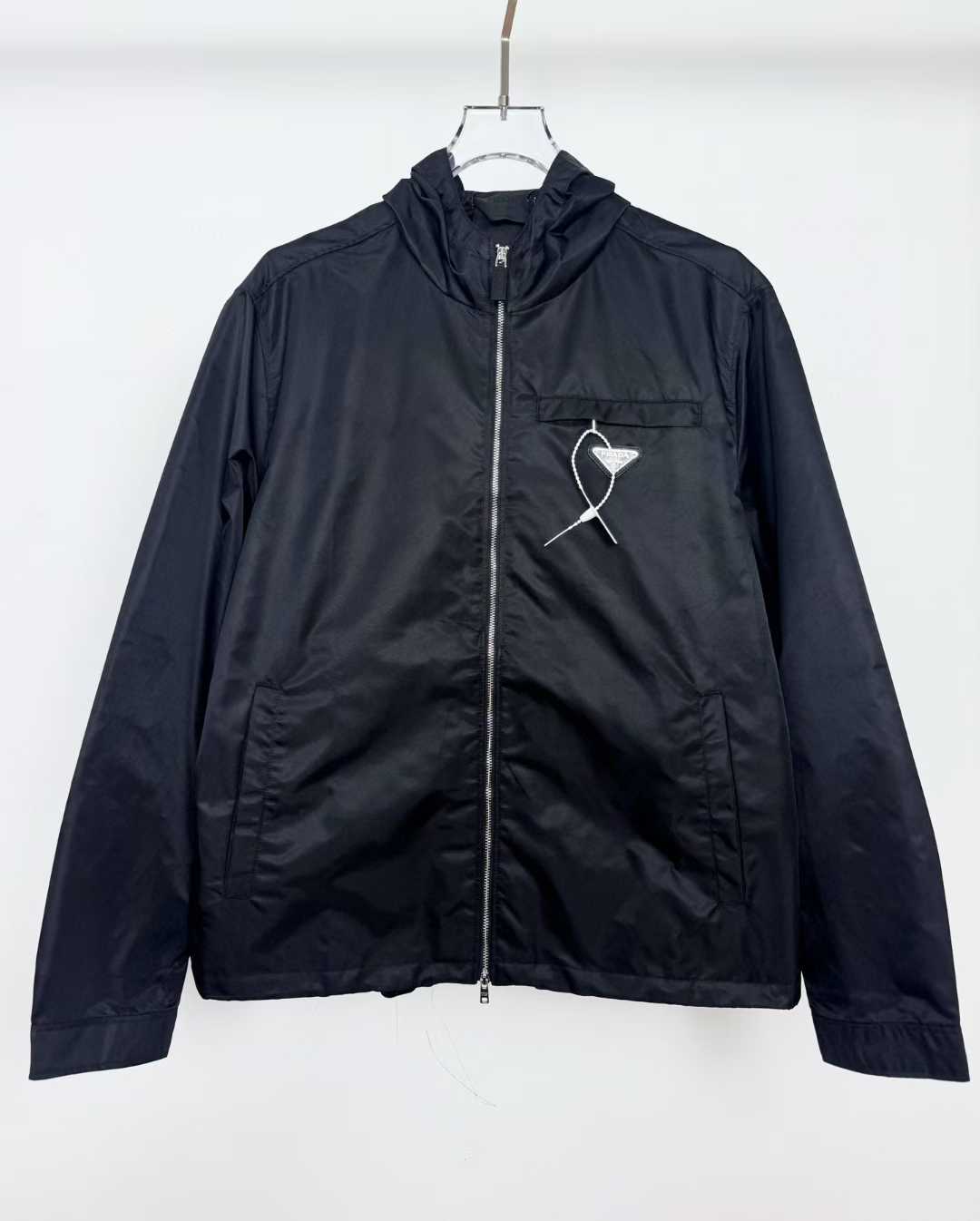 Prada Nylon Black jacket with a hood and the brand's signature triangle logo on the chest pocket.
