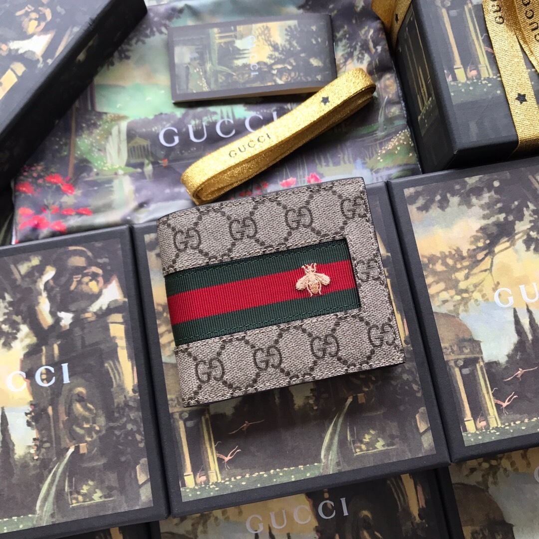 Gucci GG Supreme canvas bifold wallet with a green and red web stripe and a bee motif