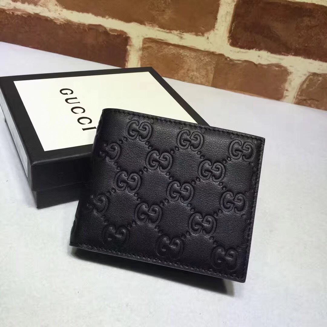 Gucci black leather bi-fold wallet signature debossed GG pattern.