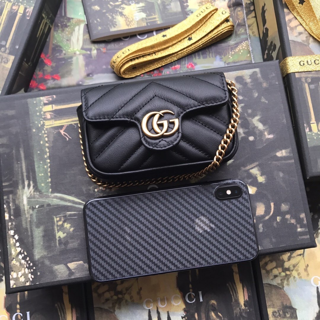 Gucci GG Marmont mini chain bag black in matelassé leather with a quilted chevron design and gold-tone hardware.