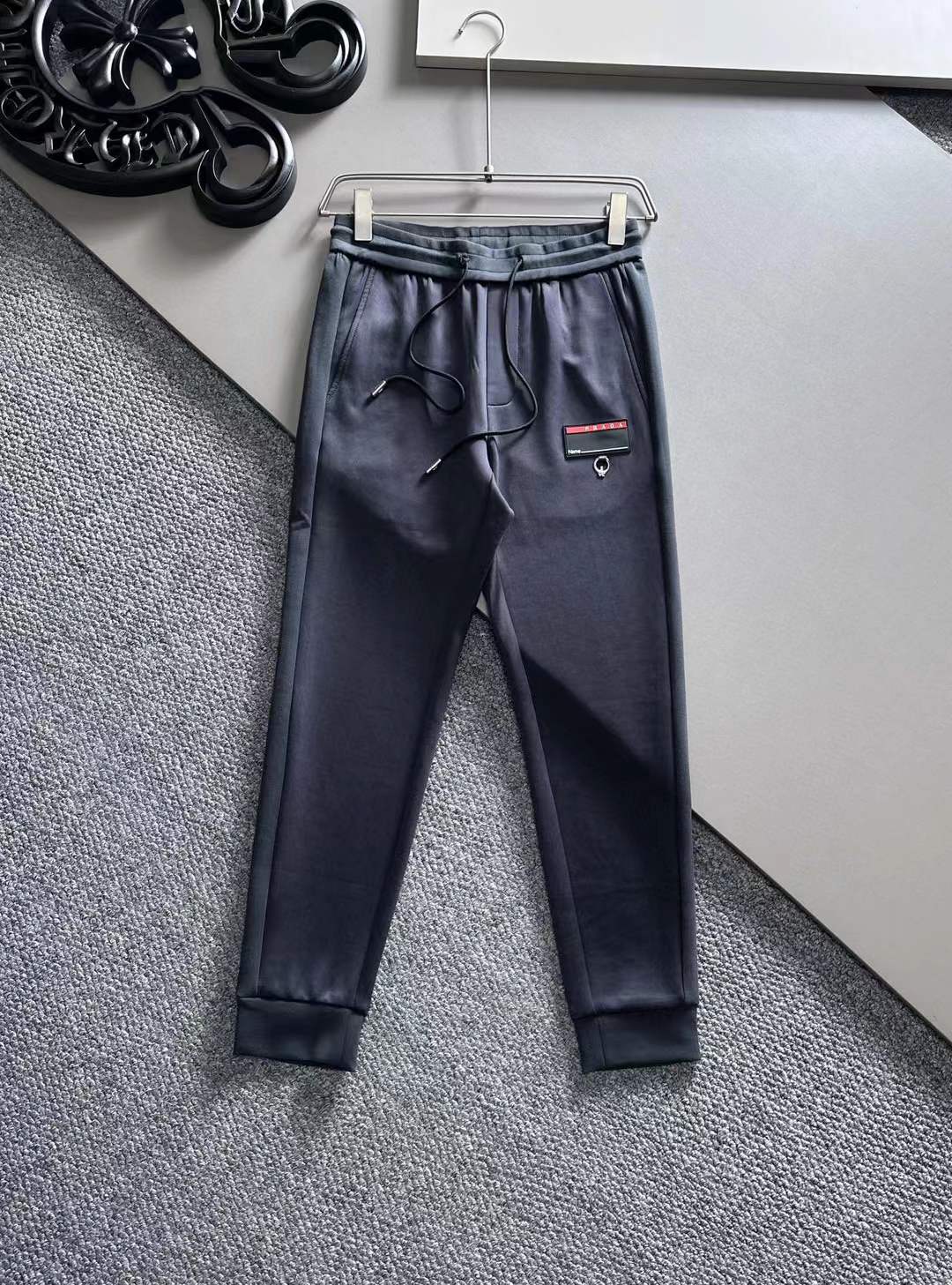 Prada track pants in a dark color with a small logo detail
