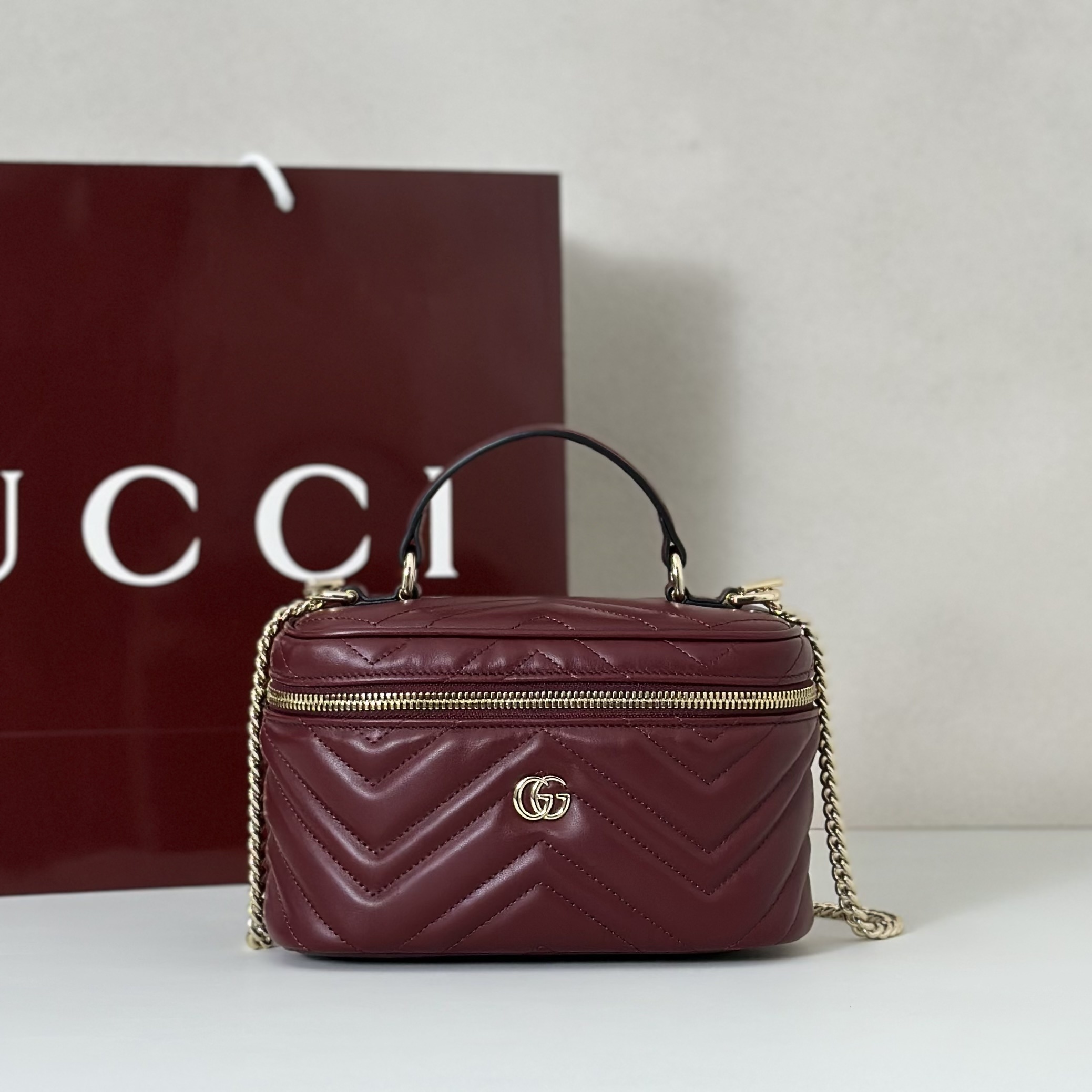 Gucci GG Marmont mini vanity bag in Rosso Ancora red matelassé chevron leather with light gold-toned hardware