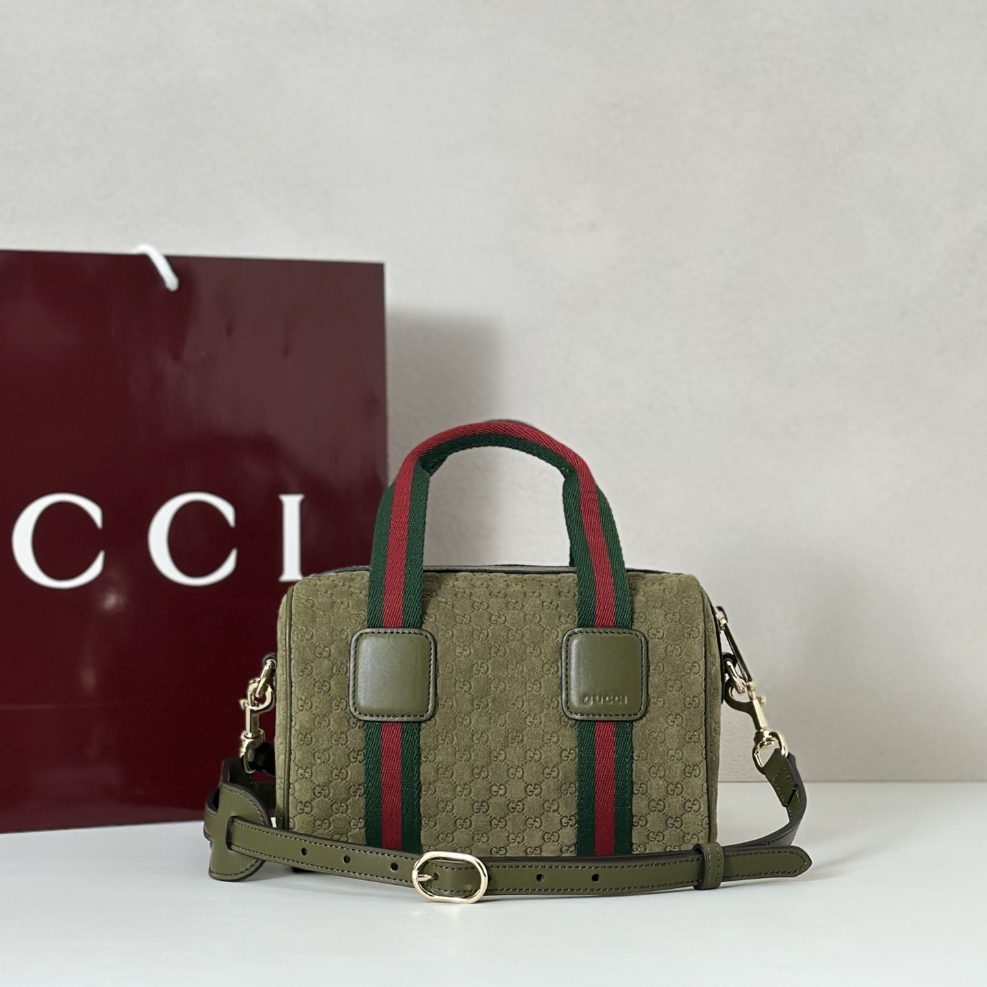 Gucci mini handbag in green suede with the signature Web stripe detail