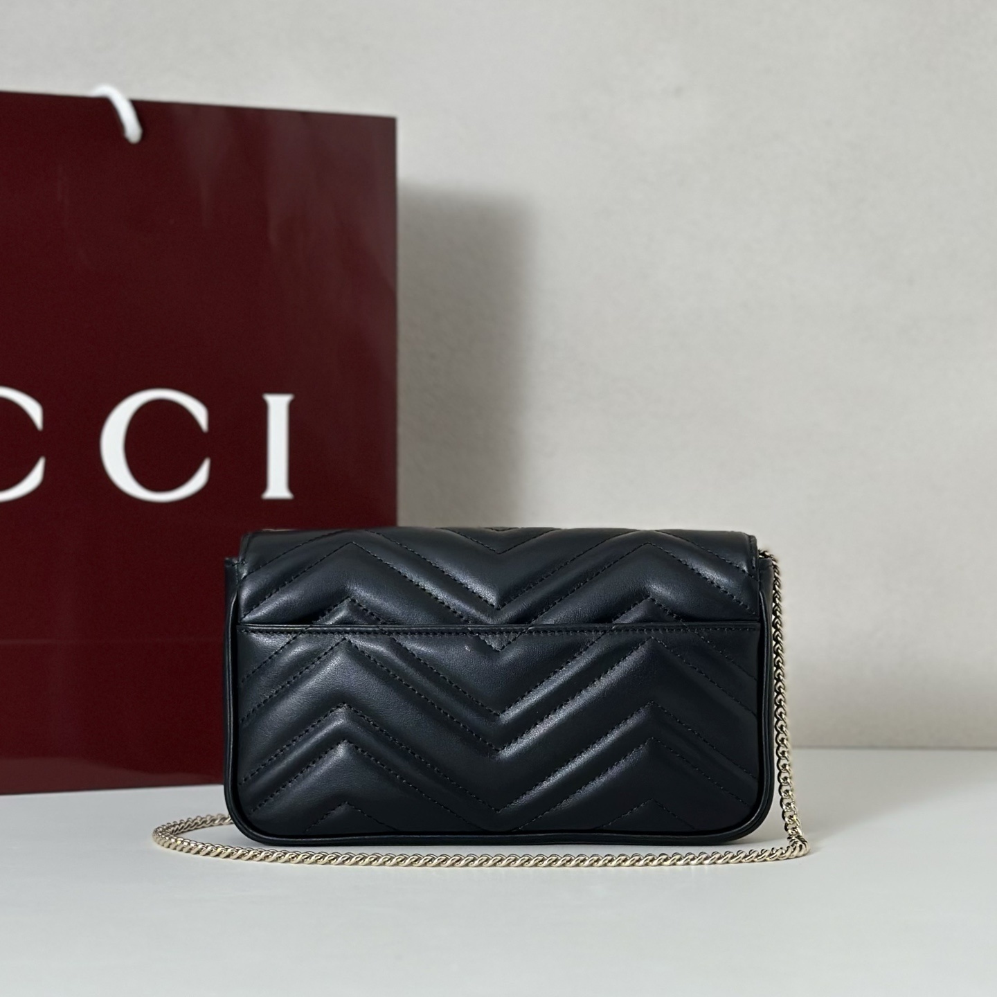 Gucci GG Marmont small shoulder bag in black matelassé leather with antique gold-toned hardware