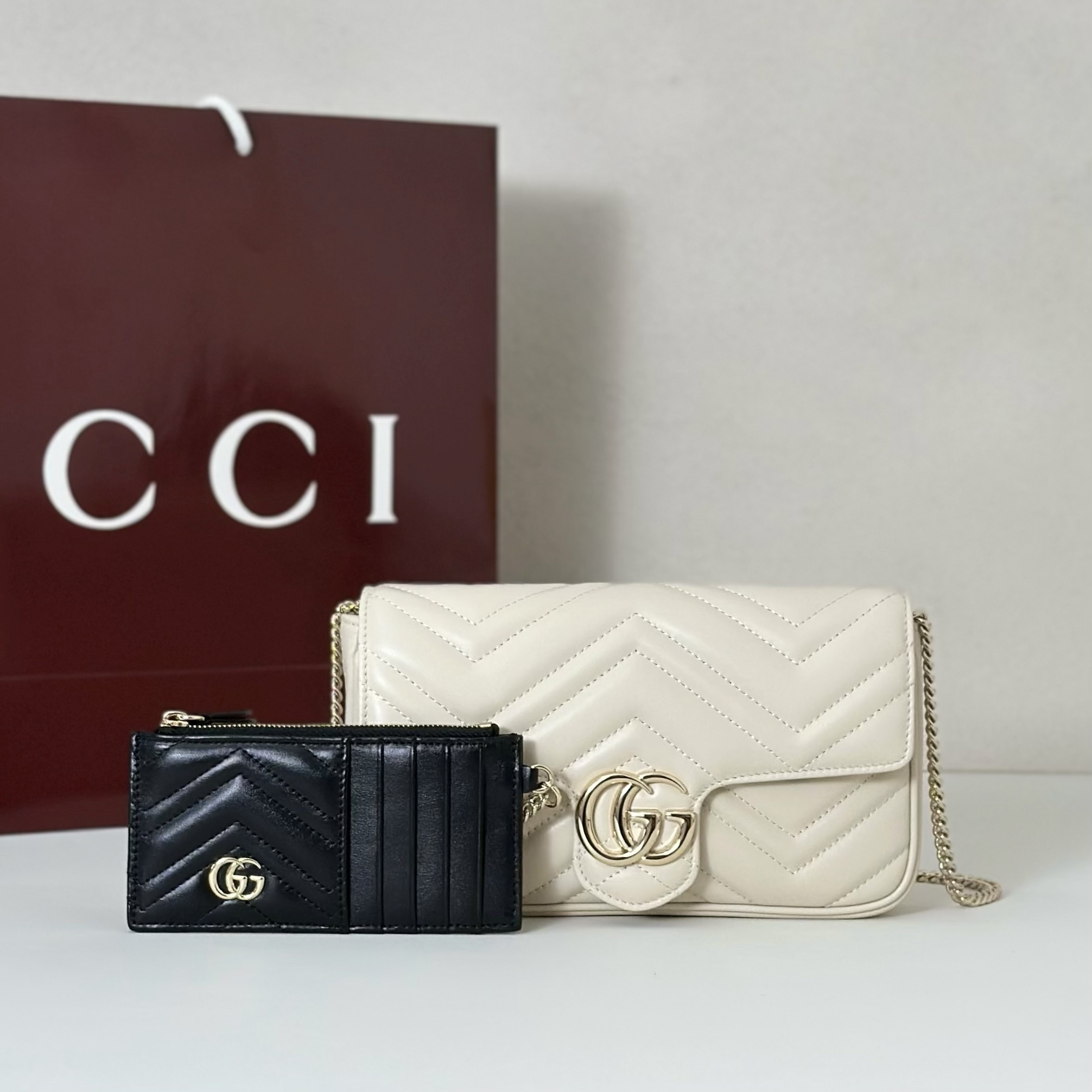 Gucci GG Marmont small shoulder bag in off-white leather and a matching black leather card holder