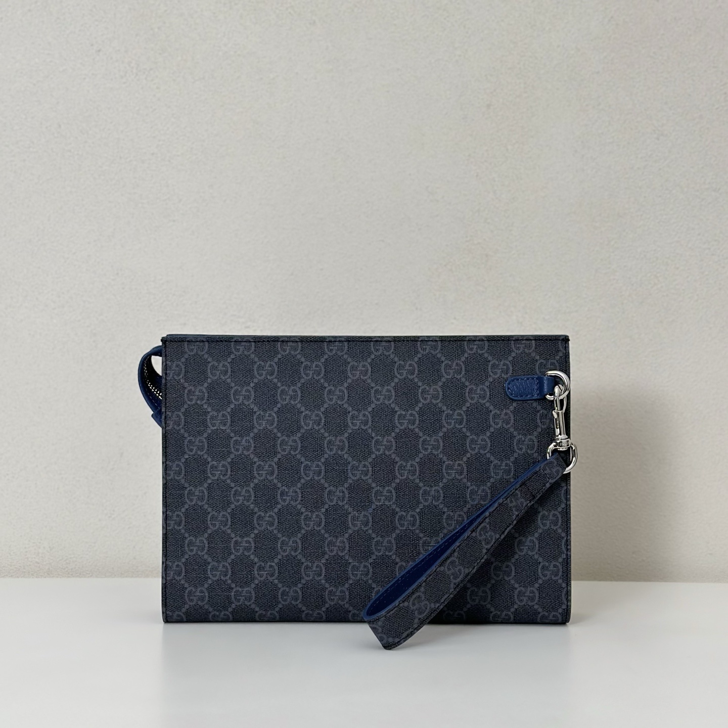 Gucci GG Supreme canvas small pouch with a detachable wrist strap and blue leather trim